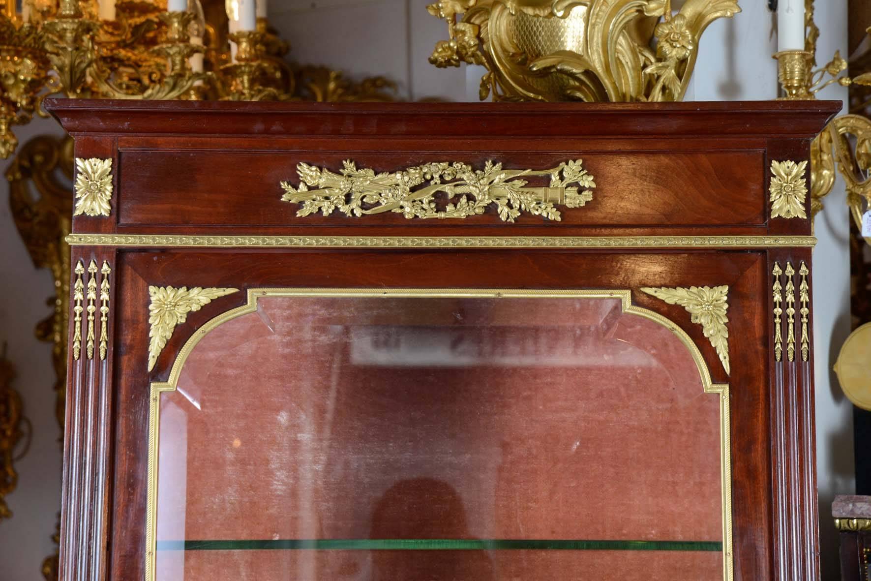 Vitrine in the style of Louis XVI mahogany decorated with gilt bronze.
It's exist a similar model by Weissweiller, in Versailles.