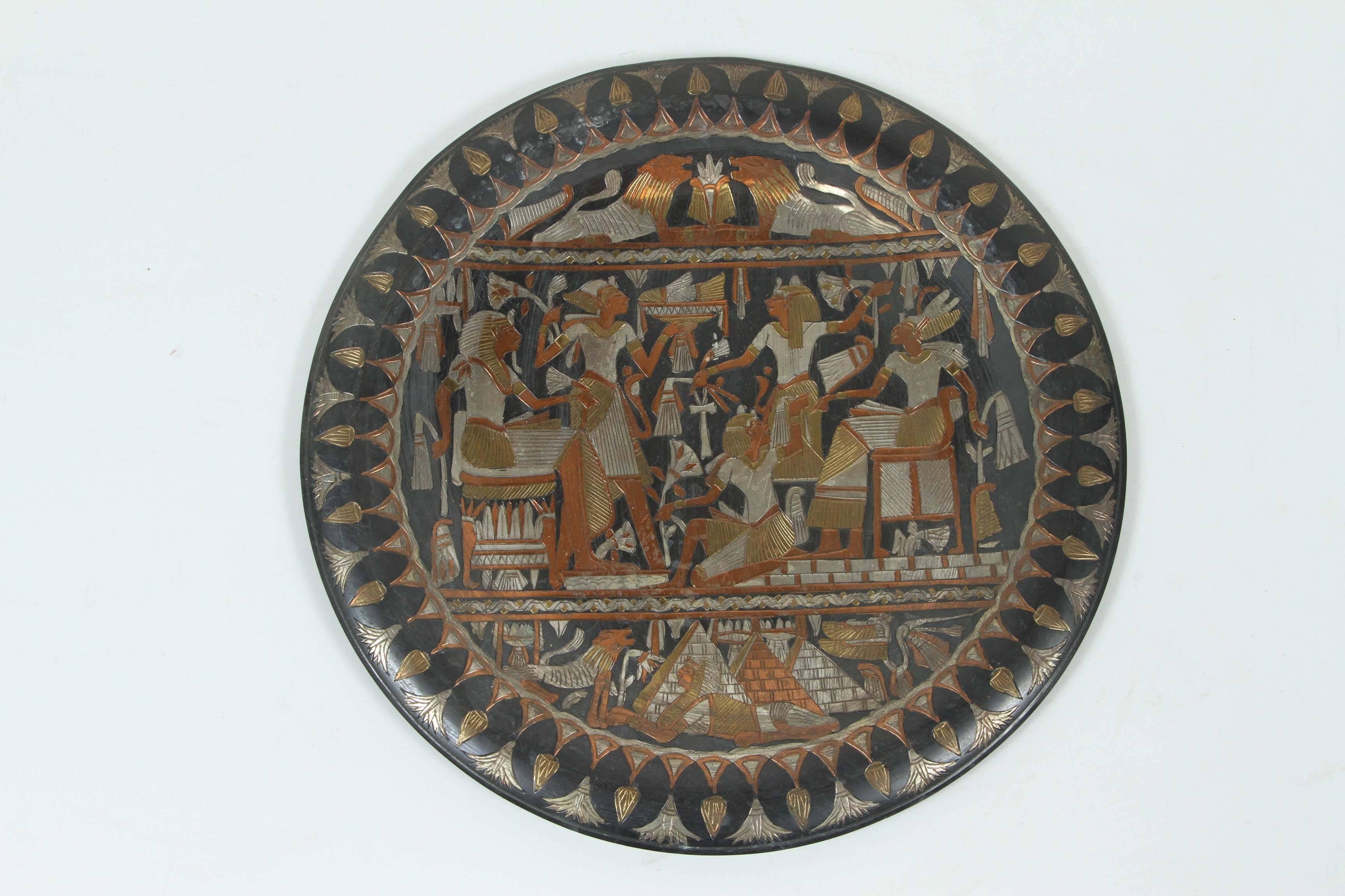Egyptian wall hanging platter or tray, black background with Egyptian Pharaonic scene.
Hand-hammered and chased and inlay with different colors of metal.