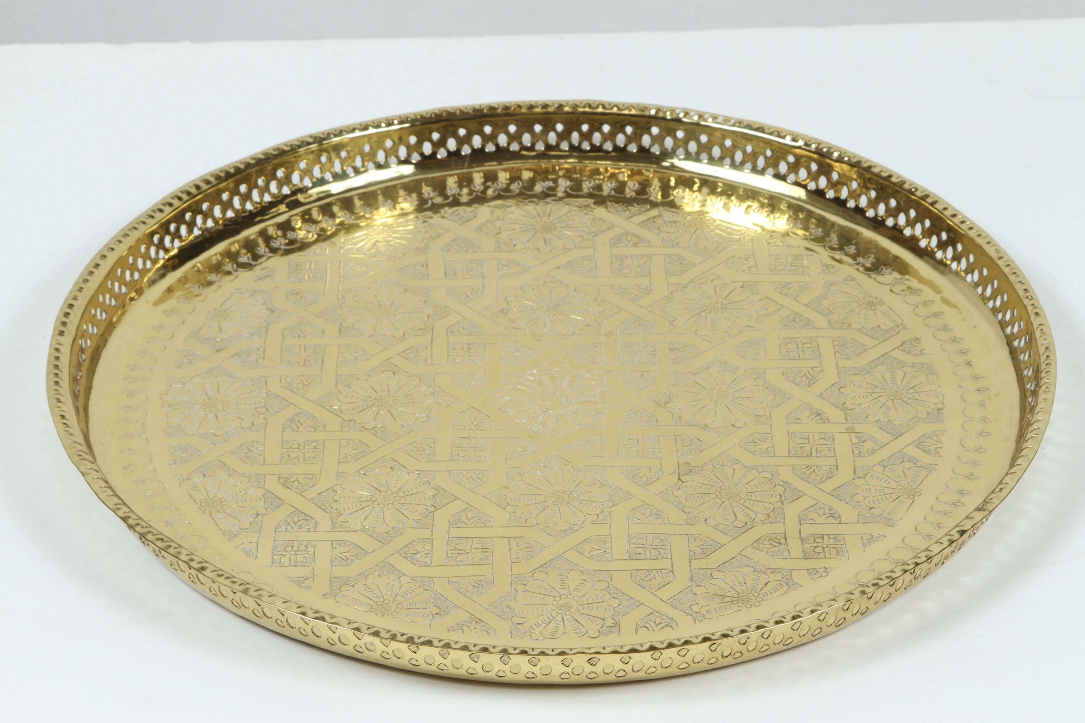 Vintage Moroccan Moorish polished round serving brass tray with traditional geometric designs.
Handcrafted by Master artisans in Fez, hand-hammered using simple tools.
Great brass decorative Islamic art object.
