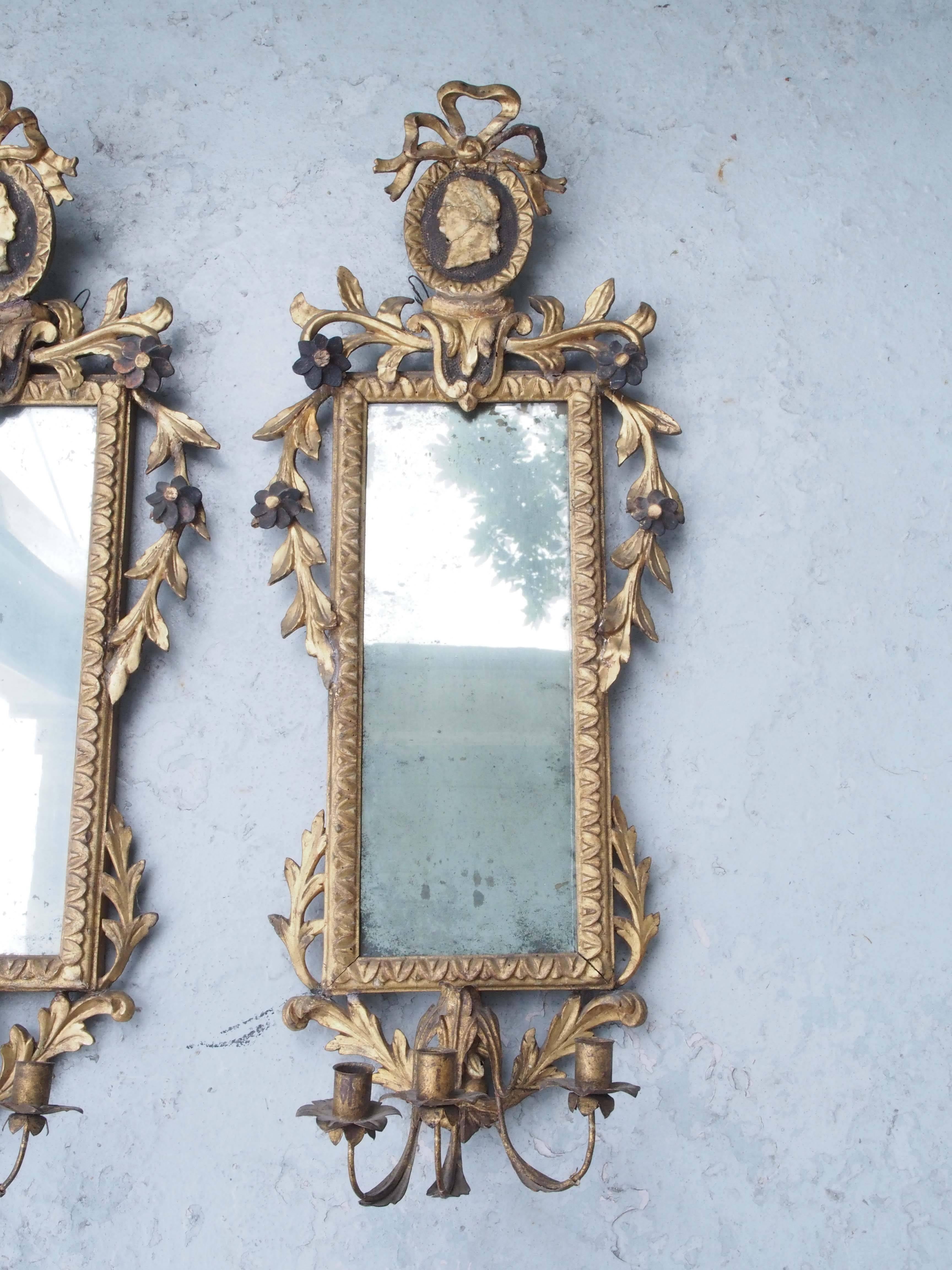 Pair of Italian Louis XVI giltwood mirrored appliqués with cameo ovals surmounted with bows having profile portraits over a floral and foliate border.
Two candle arms.