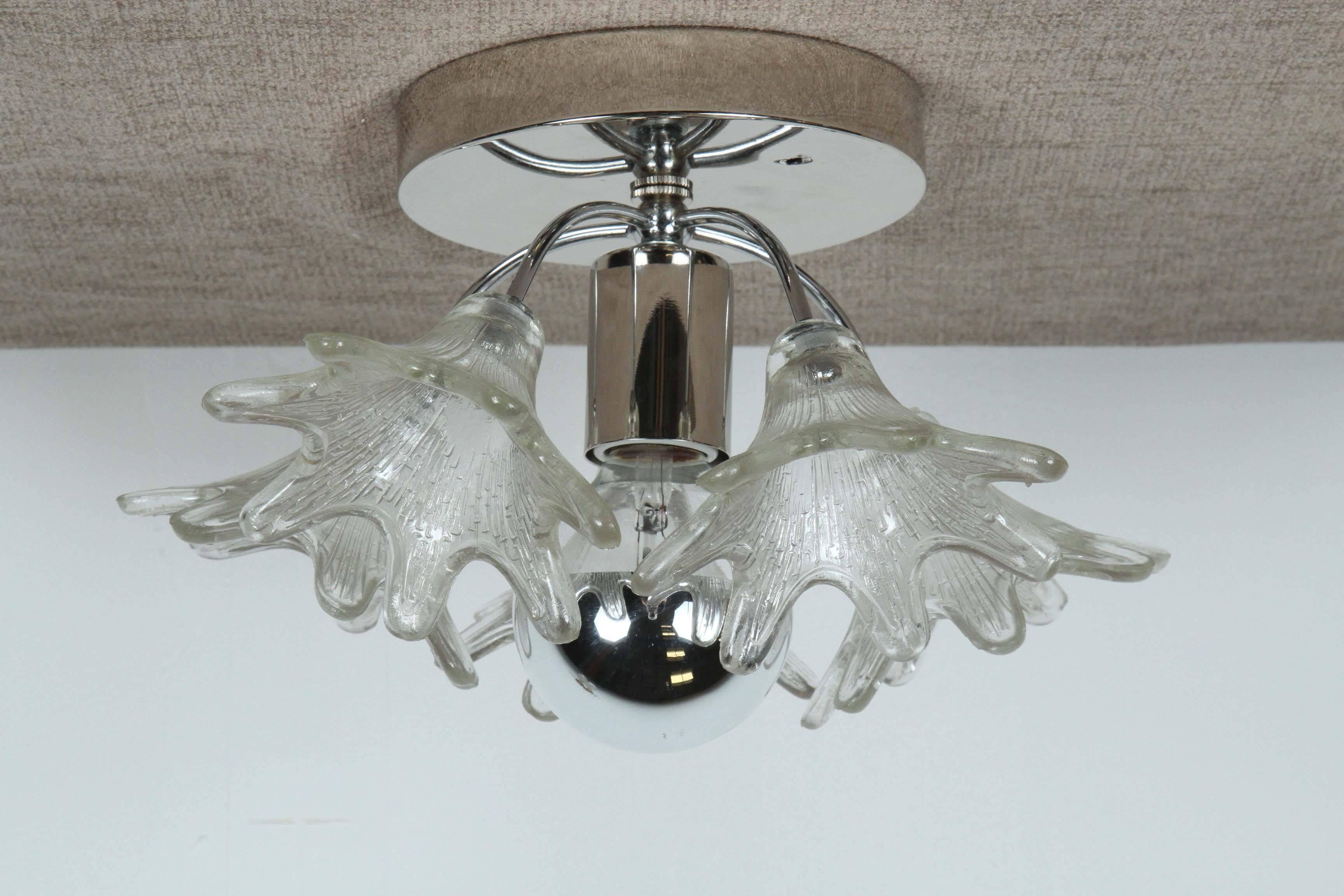 Pair of Murano flower sconces in the style of Venini.
Each sconce has five handblown glass flower elements which are mounted on to polished nickel backplates that have been newly rewired for the US with a single centre light source.
They can be