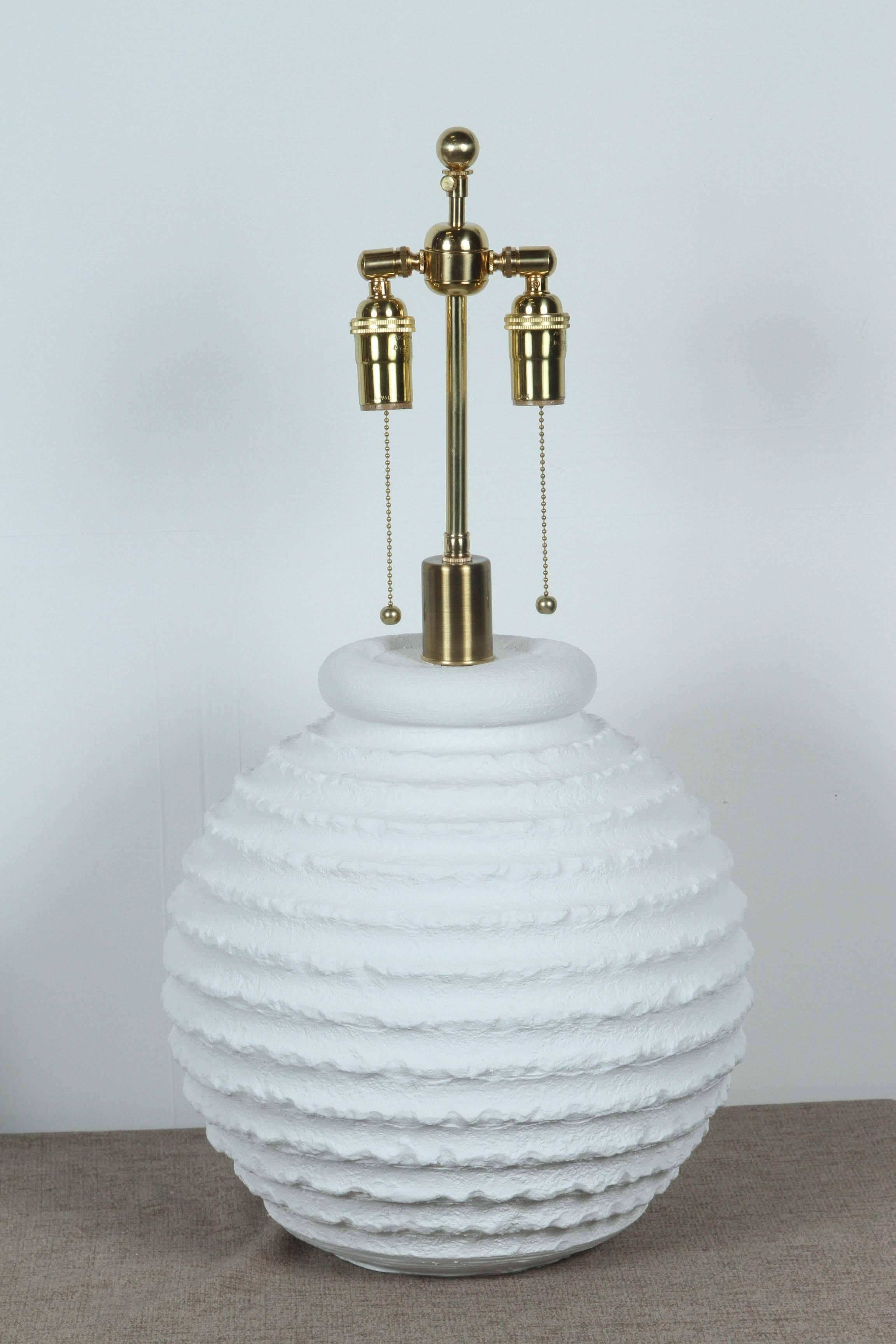 Pair of molded plaster table lamps with a flat white matte finish. 
The lamps have been newly rewired with polished brass double clusters.
