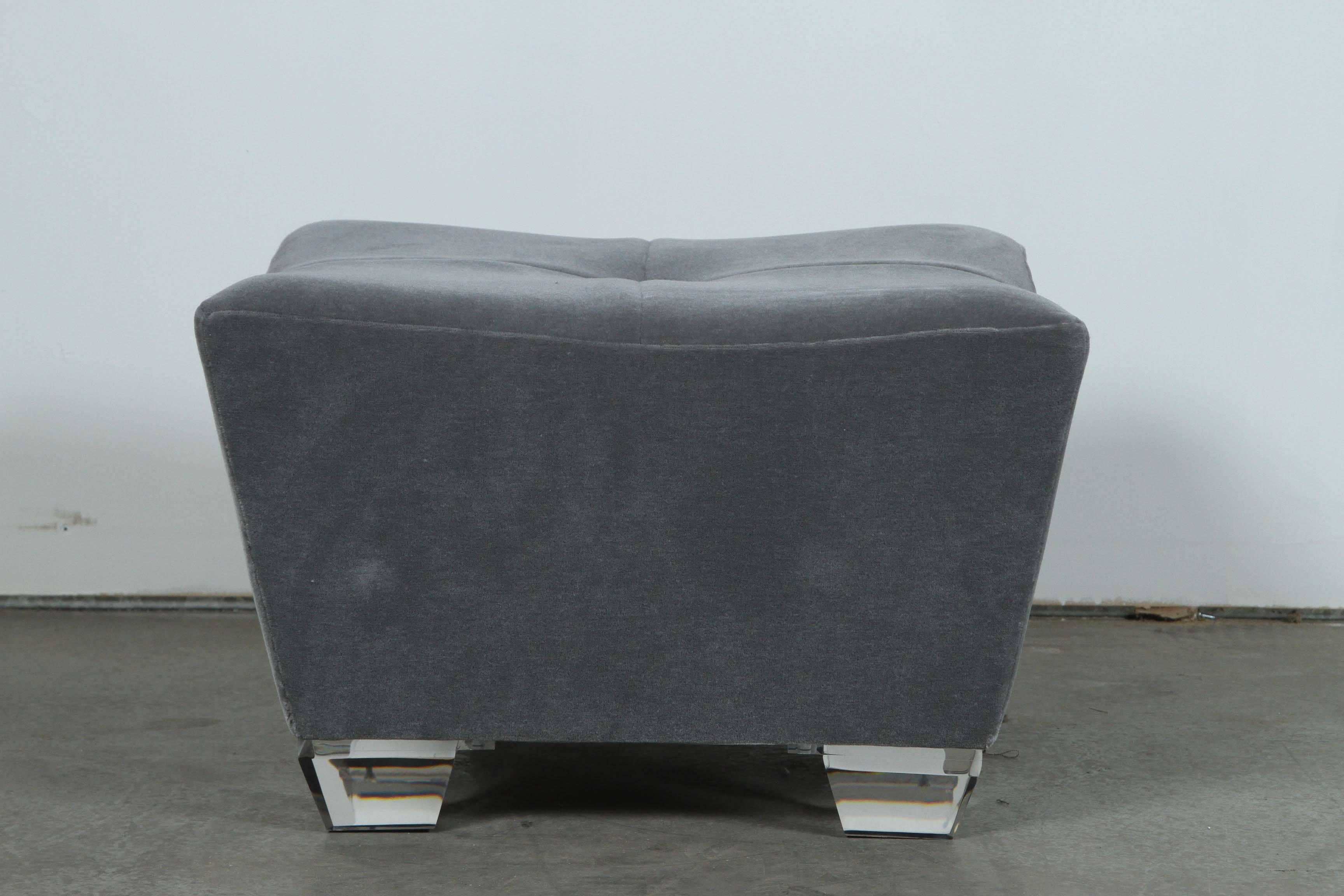 Elegant pair of Ottomans designed by our gallery.
The trapezoid frame is upholstered in a beautiful dove gray mohair fabric with
the top being quartered and finished with a large centre button.
Large Lucite trapezoid legs follow the lines of the