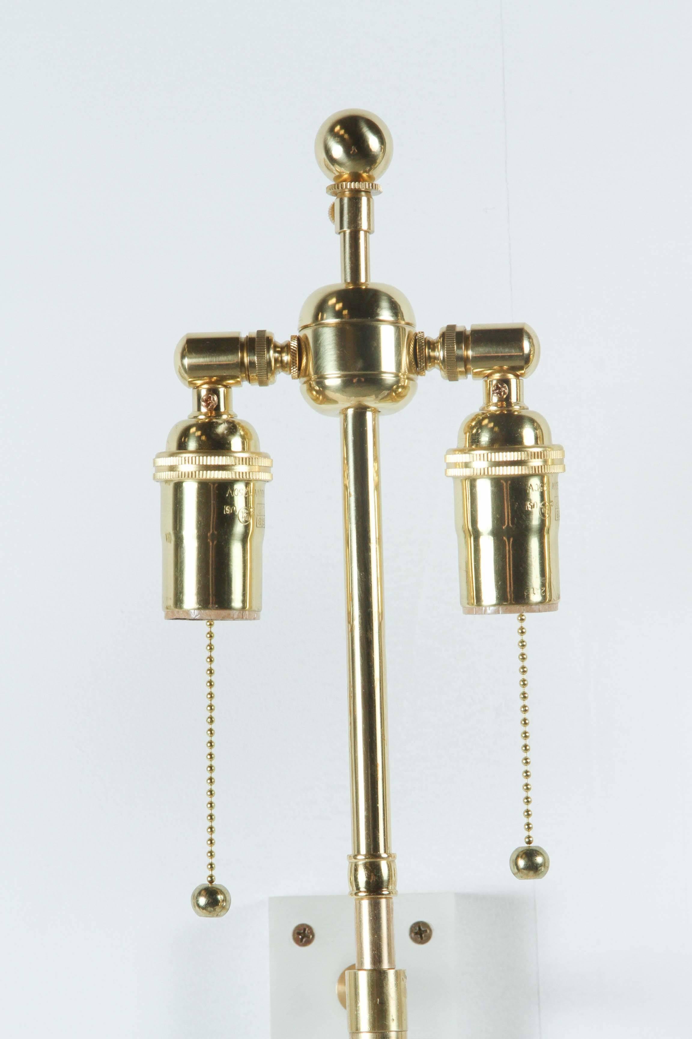 Stunning pair of Lucite and brass sconces.
The sconces have been newly rewired with polished brass double clusters
and require Demi-lune shades which are NOT included.