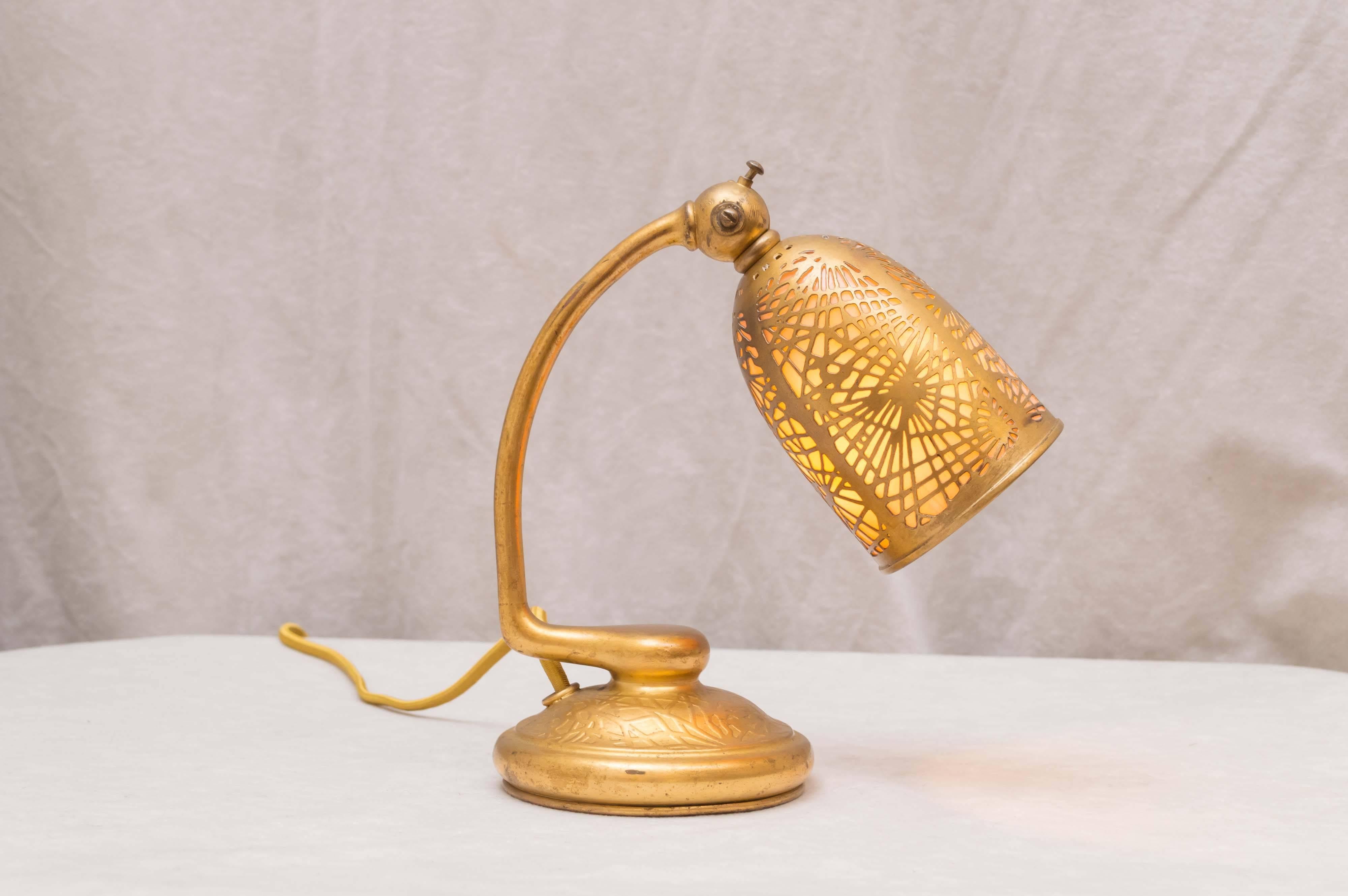How sweet this little signed, original Tiffany Studios lamp is guaranteed authentic and in beautiful condition. The angle of the shade can be easily adjusted. Put anywhere on your desk or dresser, and add something special to your world.