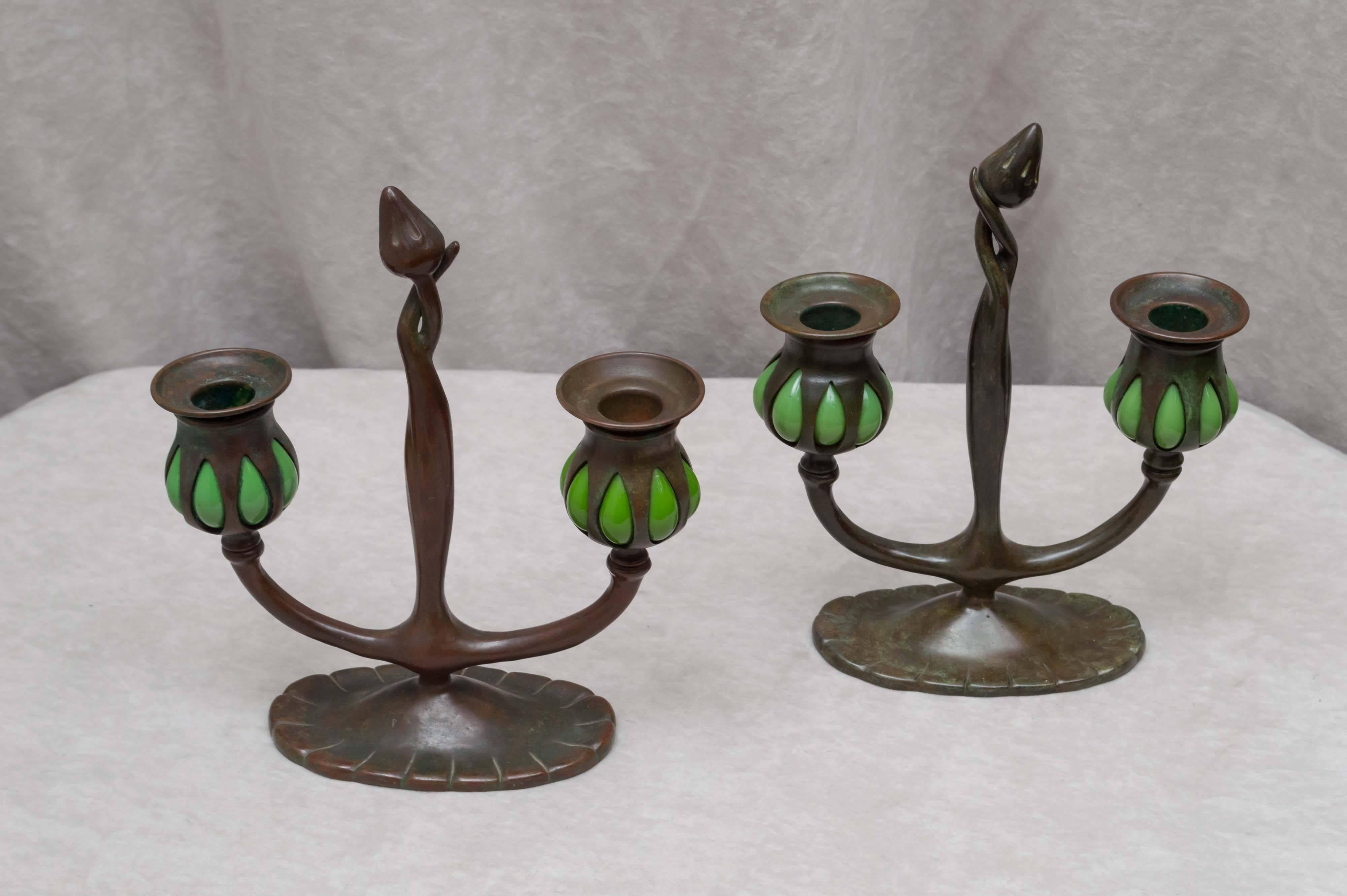 As we all know by now, Tiffany means quality. Tiffany Studios made a lot more than lamps for those who are new to collecting. These candlesticks show off some of the beauty of their accessories. Rich warm patina and blown glass help make these so