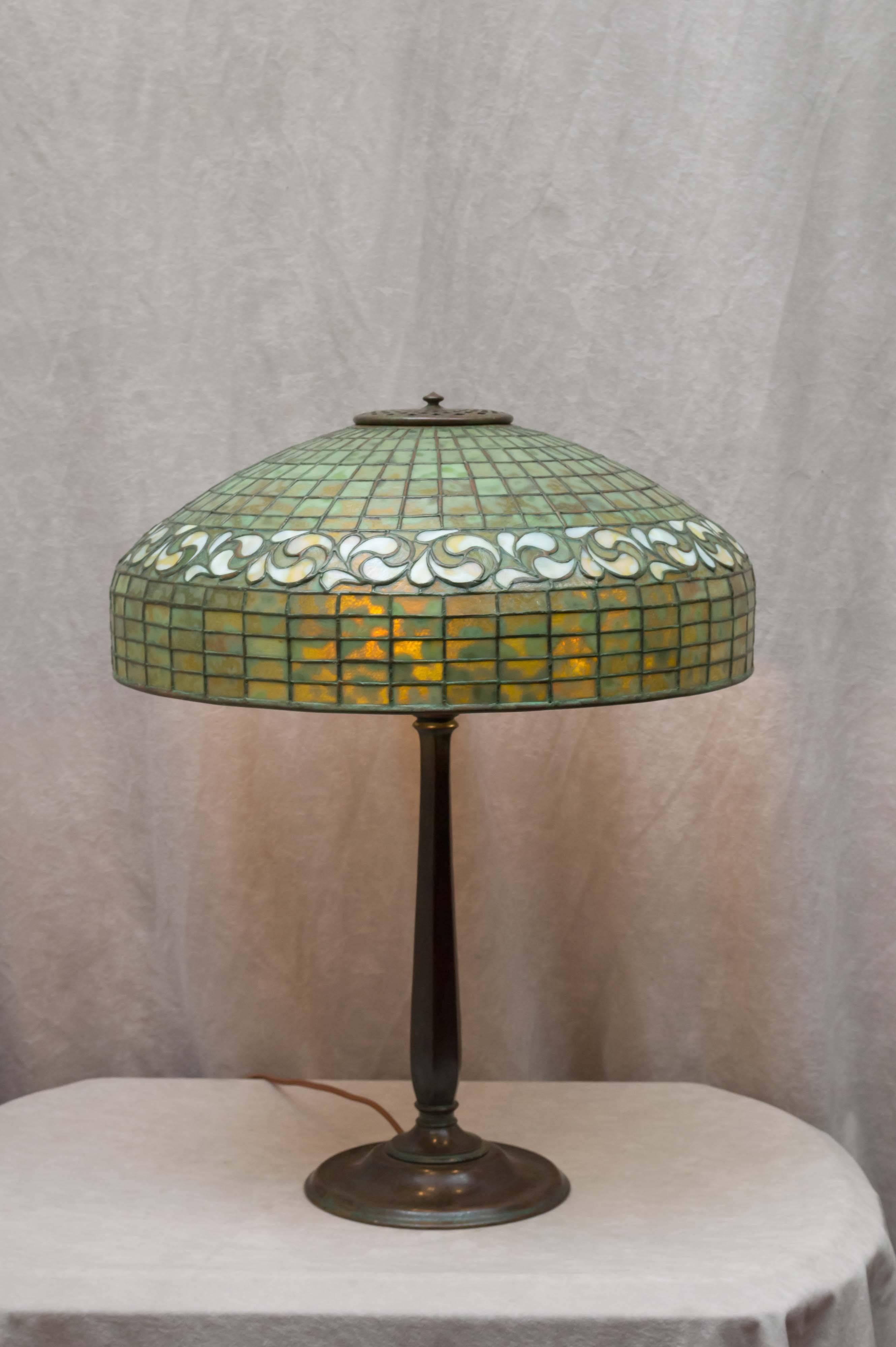 This all signed Tiffany Studios lamp has some of the most mottled glass you can find. Tiffany enjoyed showing off some of his best glass on his simpler patterned lamps. A stunning model, and on a simple, appropriate base. A great package for someone