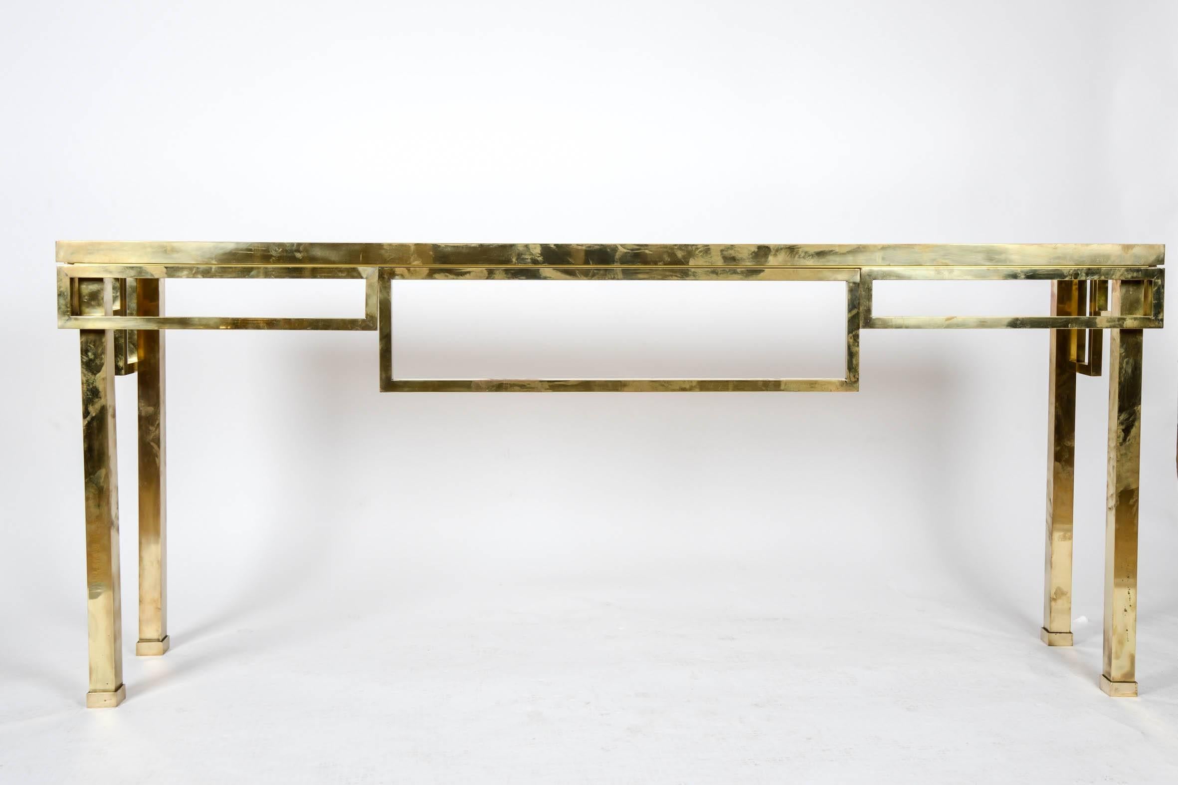 Large brass console with square legs, top in smoked glass.
Price for one piece