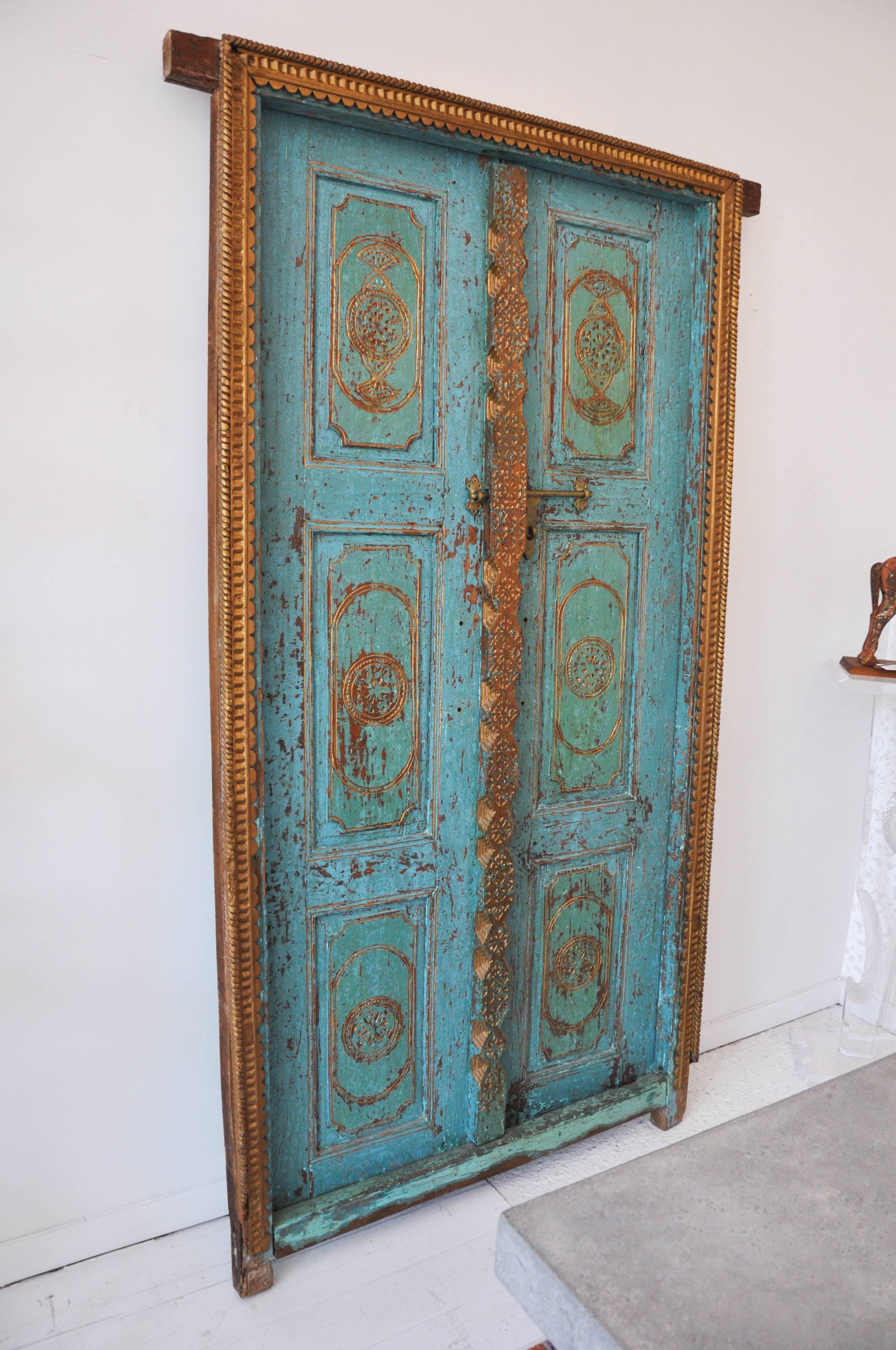 Pair of exquisite salvaged doors from India. The colors, gilded frame and original hardware are quite breathtaking.