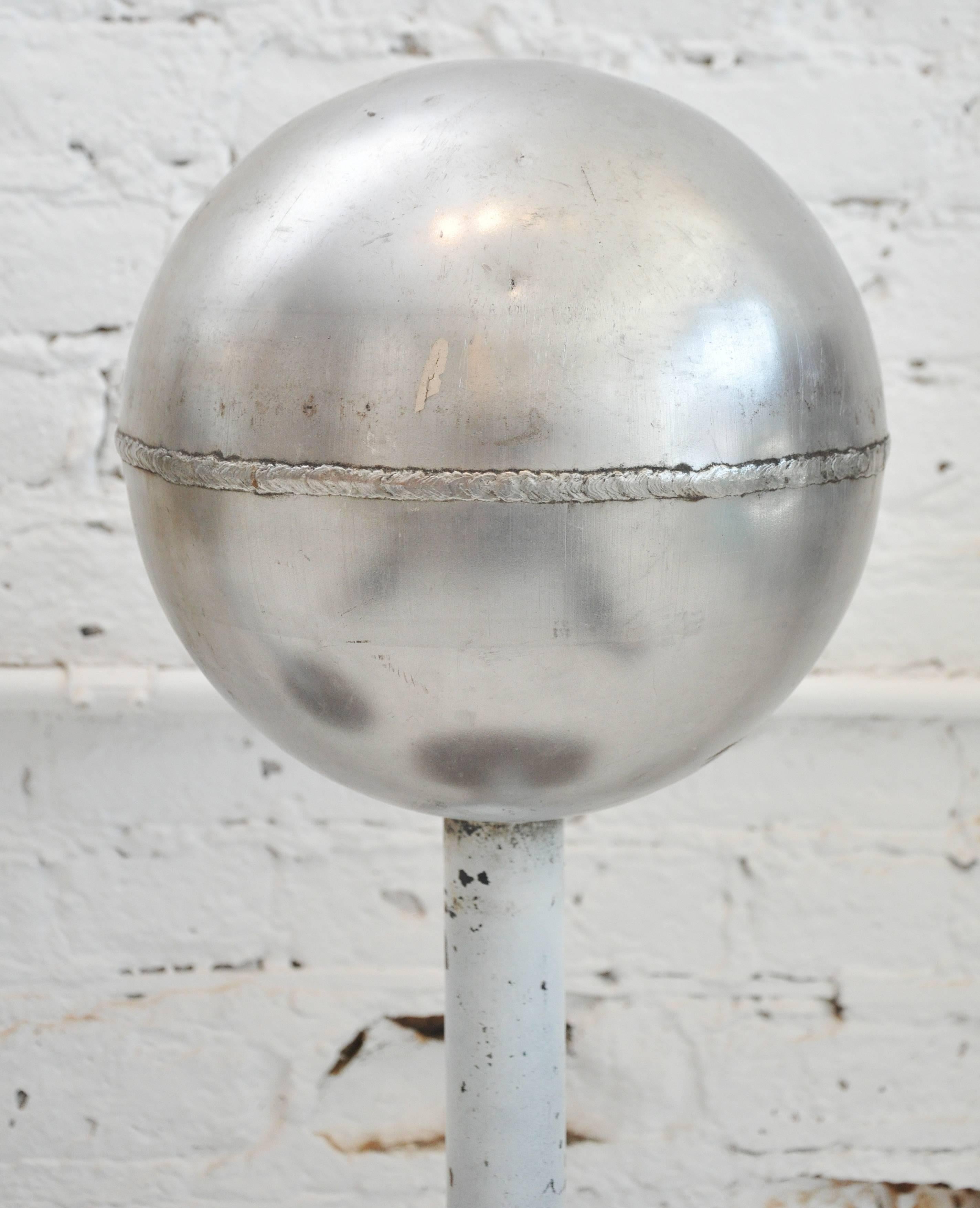 This pair of sculptural orbs are striking objet that will fascinate within any space. The mix of metal and their various patina make for a one-of-a-kind design statement!