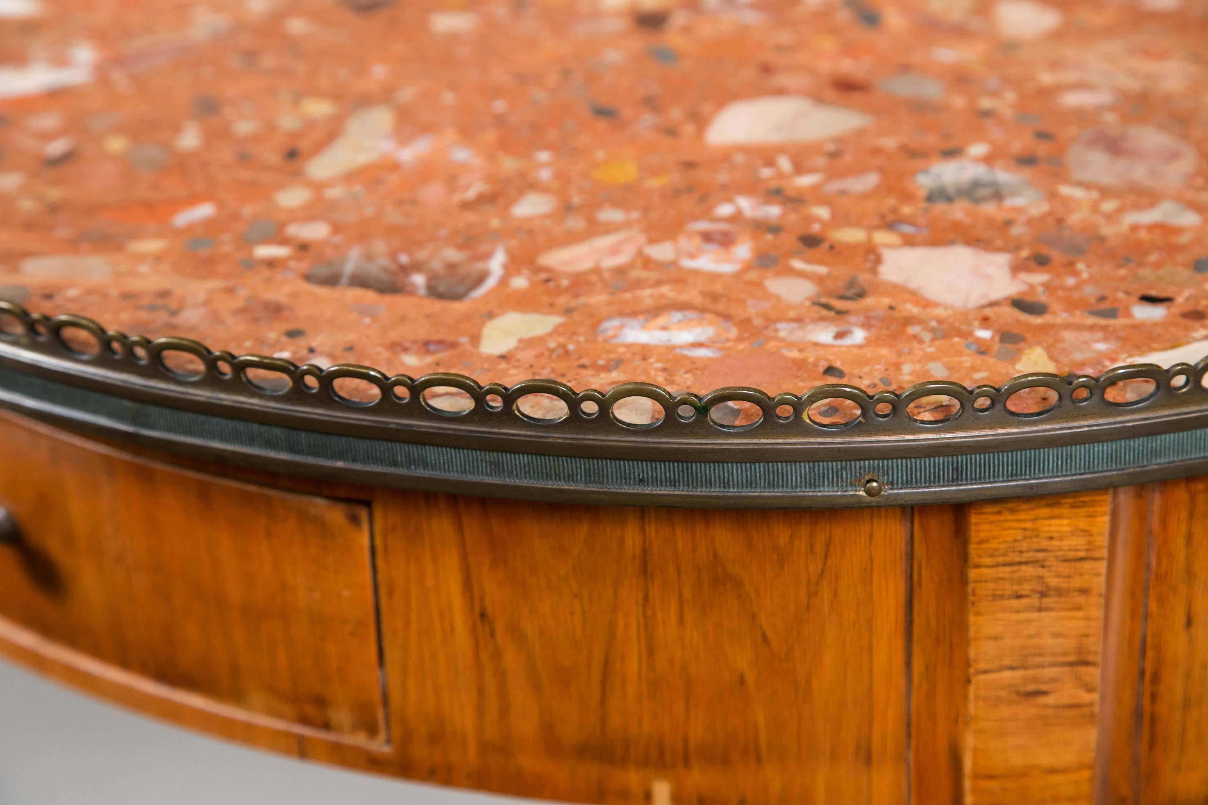Dating from the late 19th century this table has a Rosso Verona marble top. There are two drawers on opposing sides and two leather topped pull-outs.