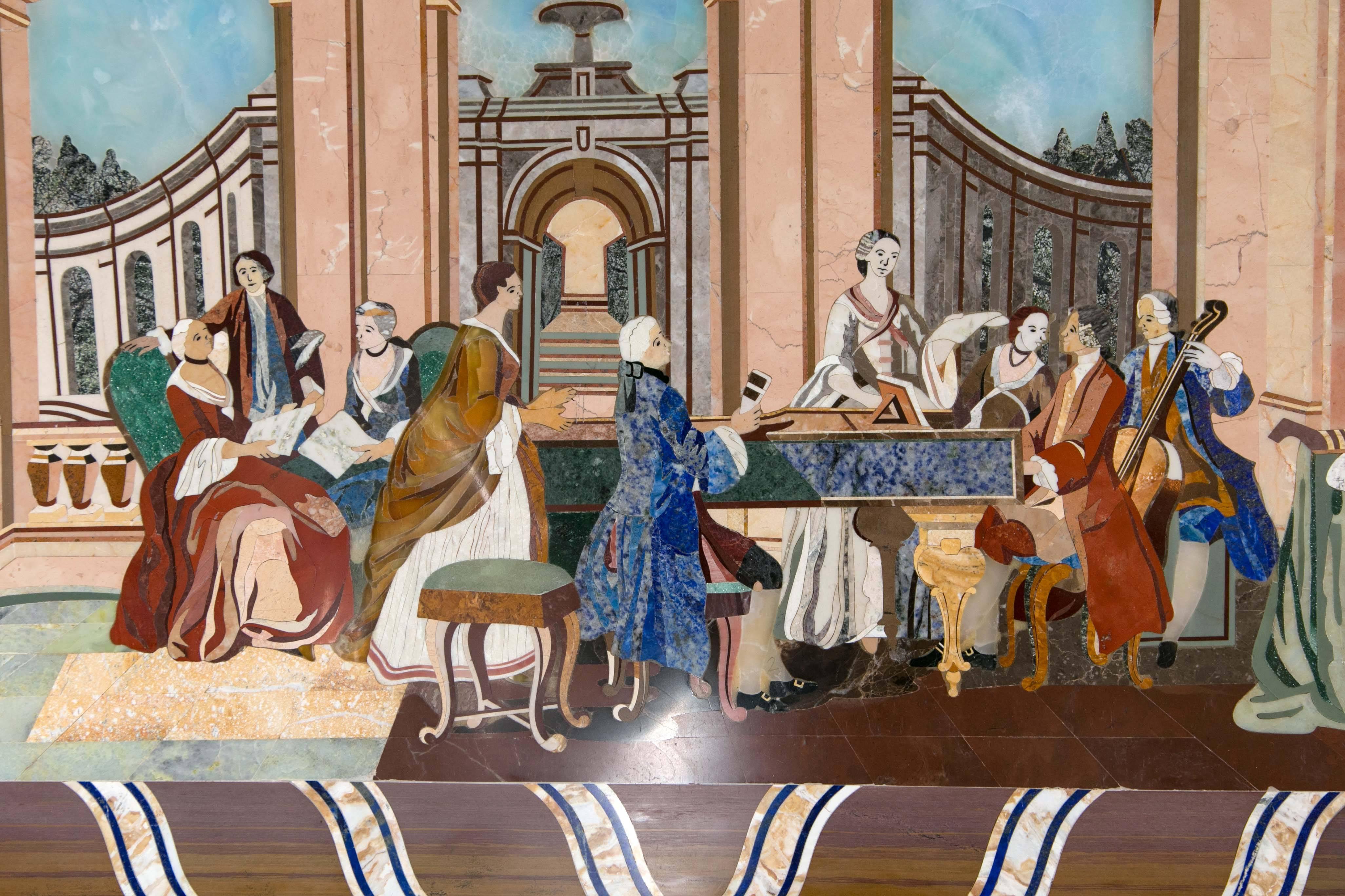 This interesting hand worked Pietra Dura scene of a recital is self framed. A gentleman plays piano while a lady holds a sheet of music or lyrics, a bassist plays to the side while others watch or appear uninterested on the left side. The all wear