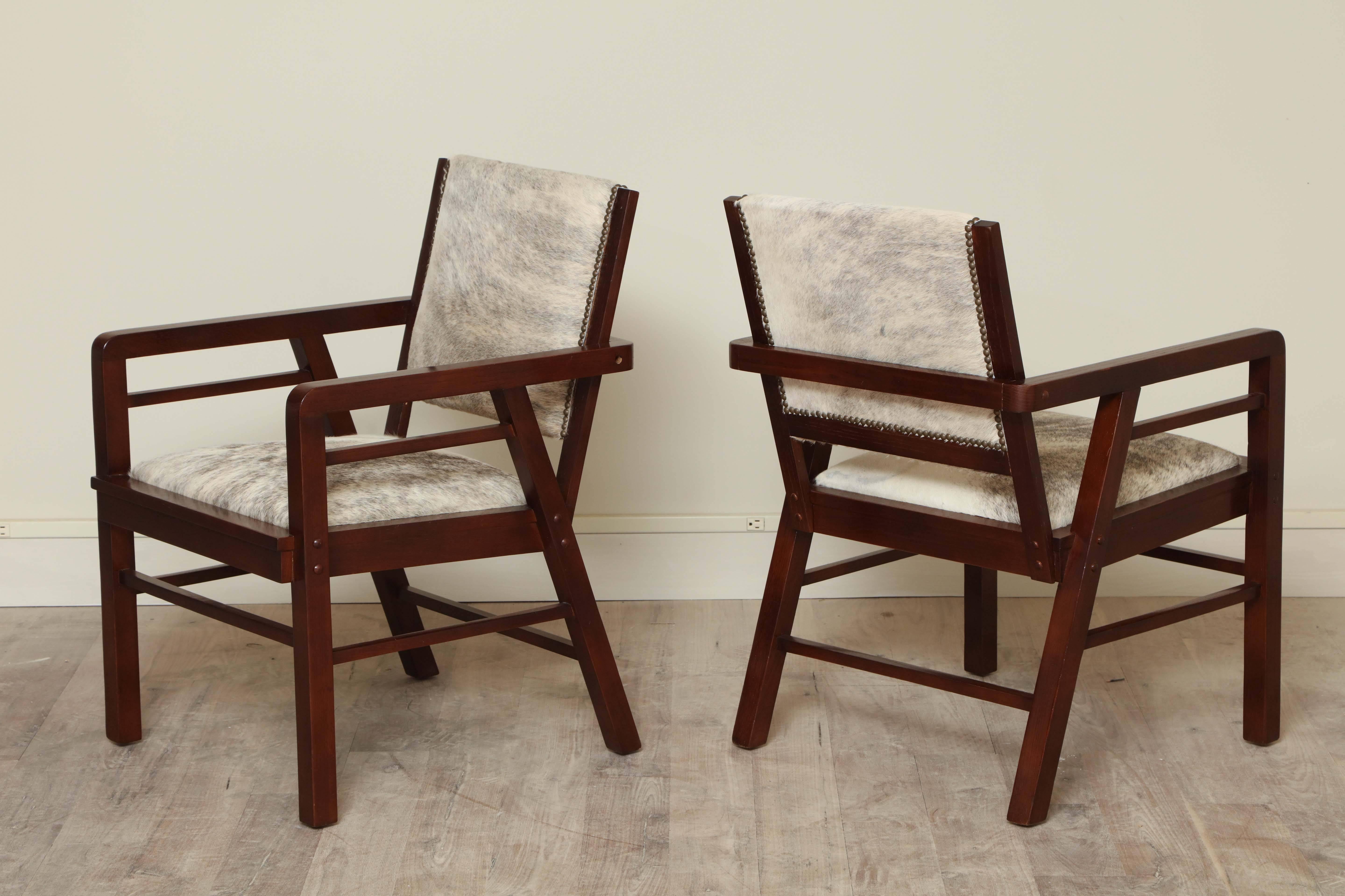 Pair of oak armchairs circa 1940 with hair on hide upholstery and mahogany finish.