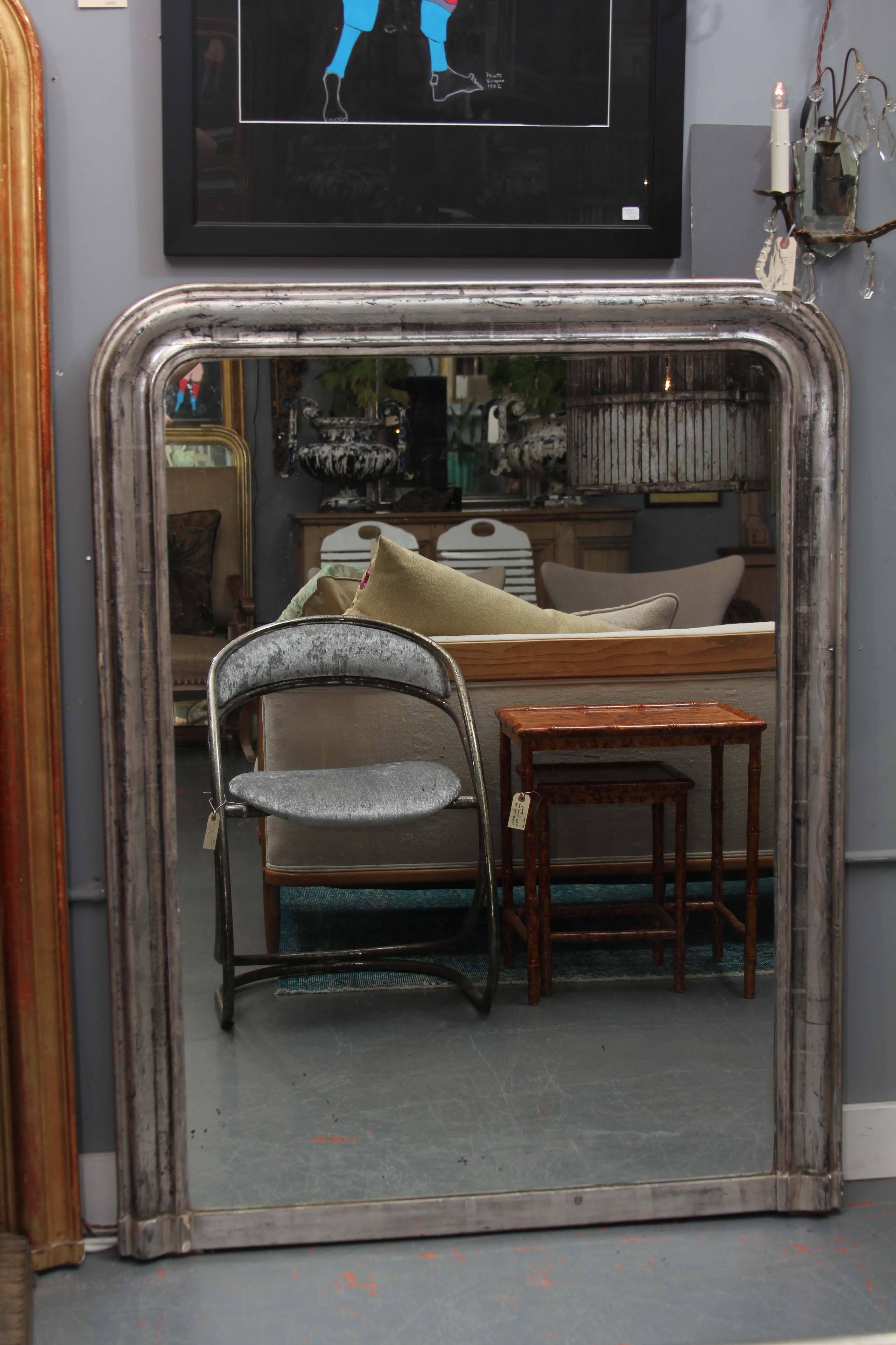 Large Louis Philippe style mirror in silver with nice black accents in finish.