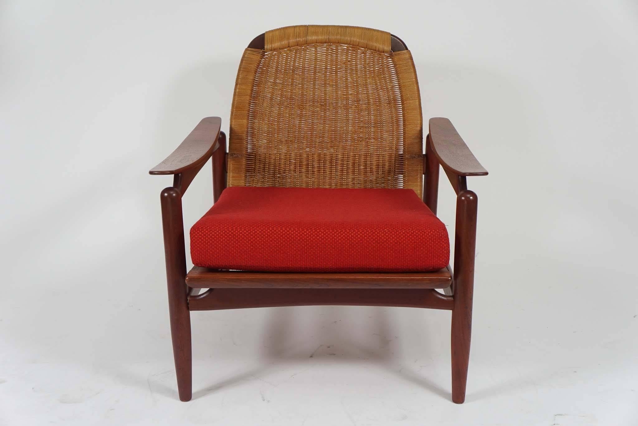 Fantastic pair of Mid-Century Danish modern lounge chairs. Teak and woven cane backs. Wonderful floating arm detail. Loose cushions can easily be reupholstered or use as is. Great condition.