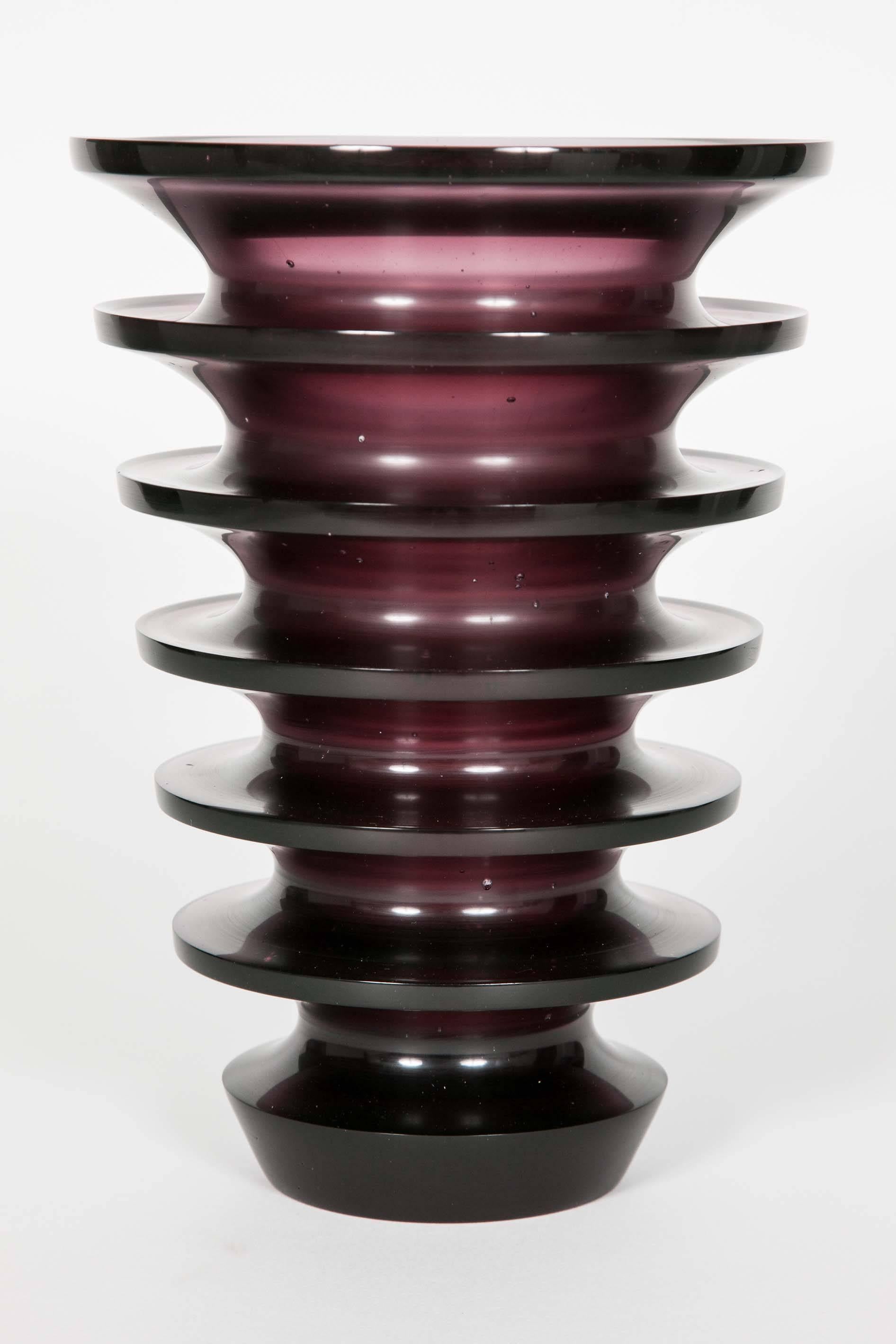 Leila is a cast glass artwork in a beautiful soft dark purple / blackberry colour by the British artist Paul Stopler. With a ridged exterior and smooth interior, the form is first turned in wax from which this is cast.

Using a complex series of