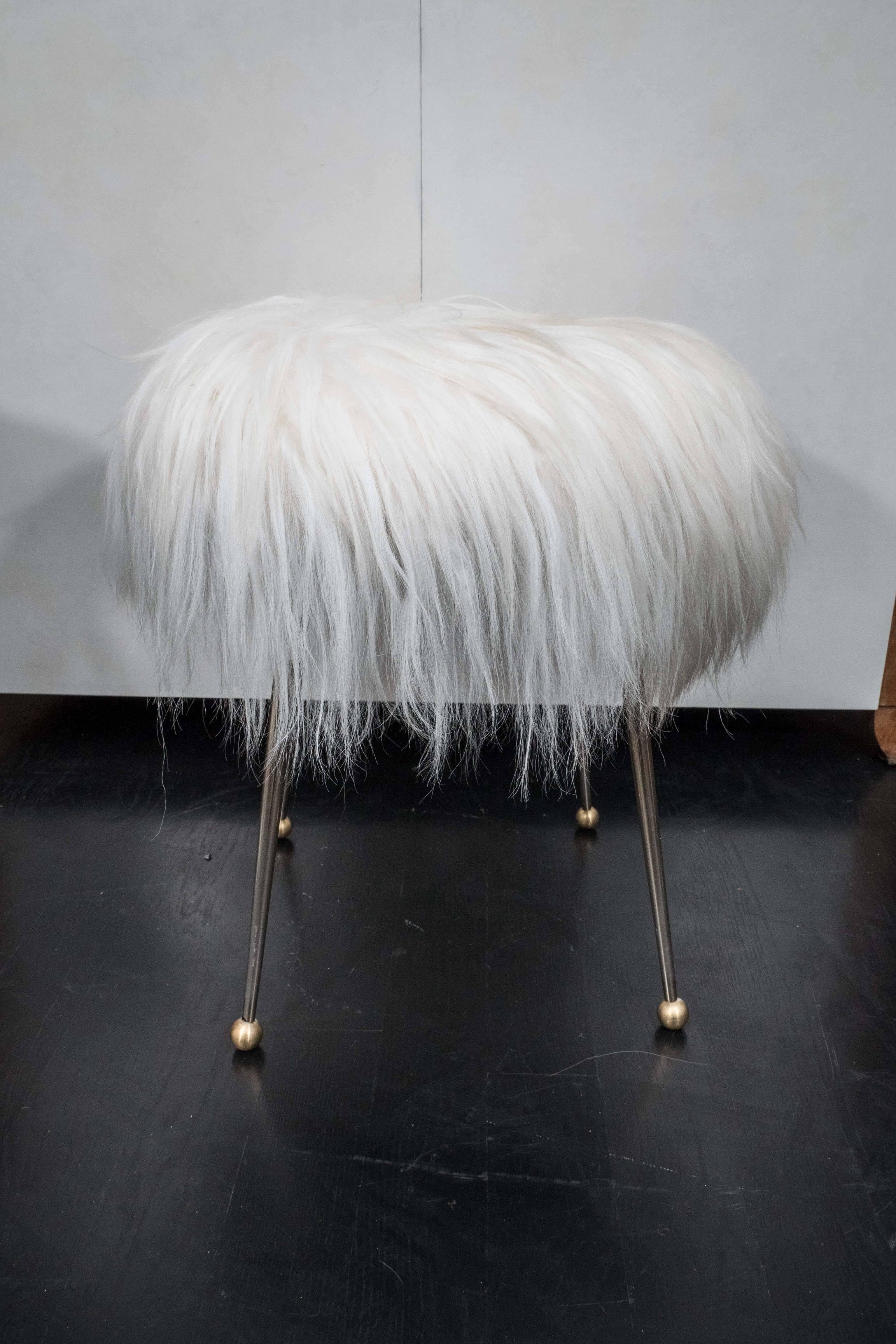 Pair of vintage stools from France. Brass legs with Mongolian fur seats.