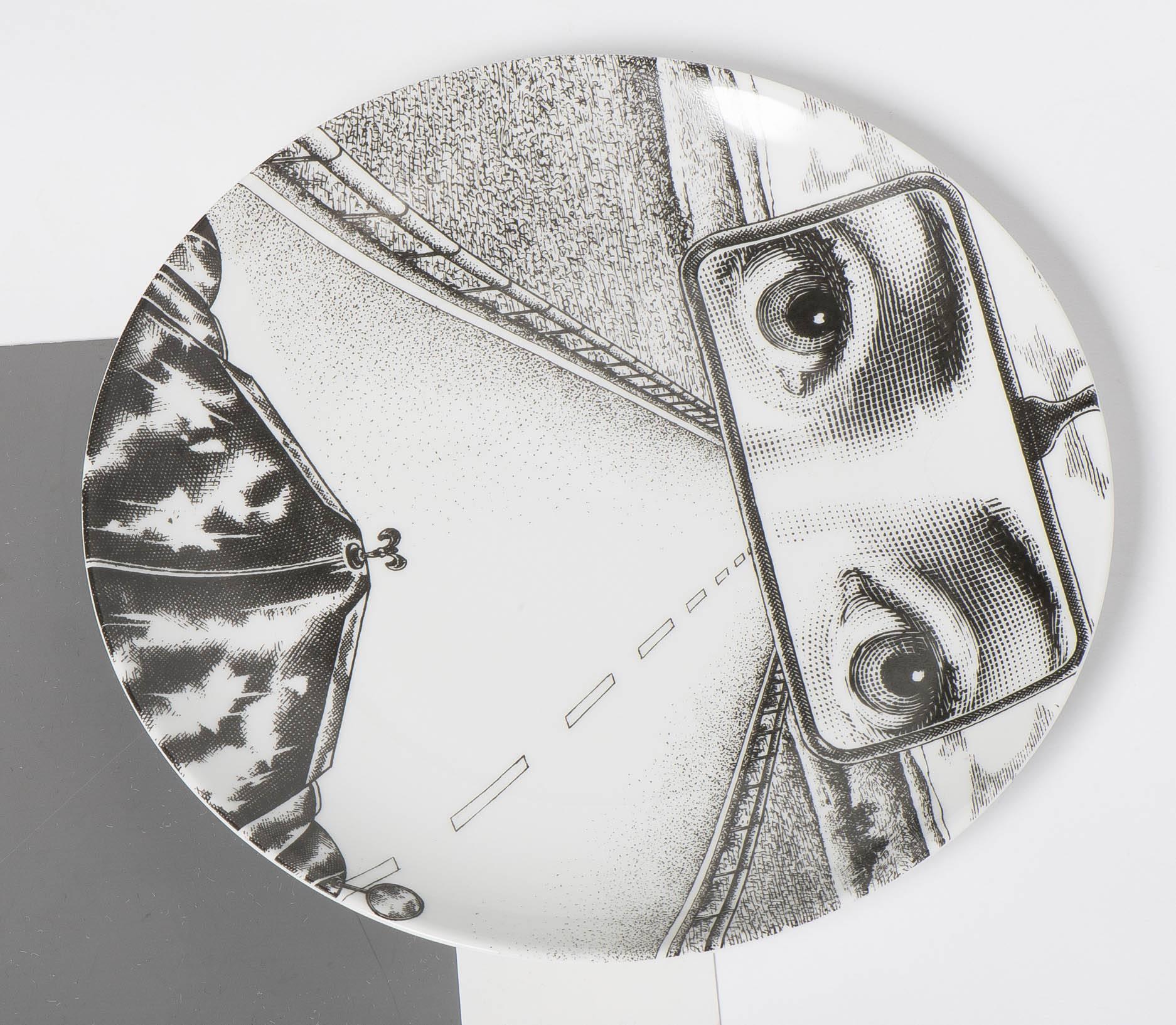 A porcelain plate by Atelier Fornasetti.
“Themes and Variations”
Lithographically printed.
Marks to back.
Italy, circa 1990.
Measures: 26 cm diameter.
 