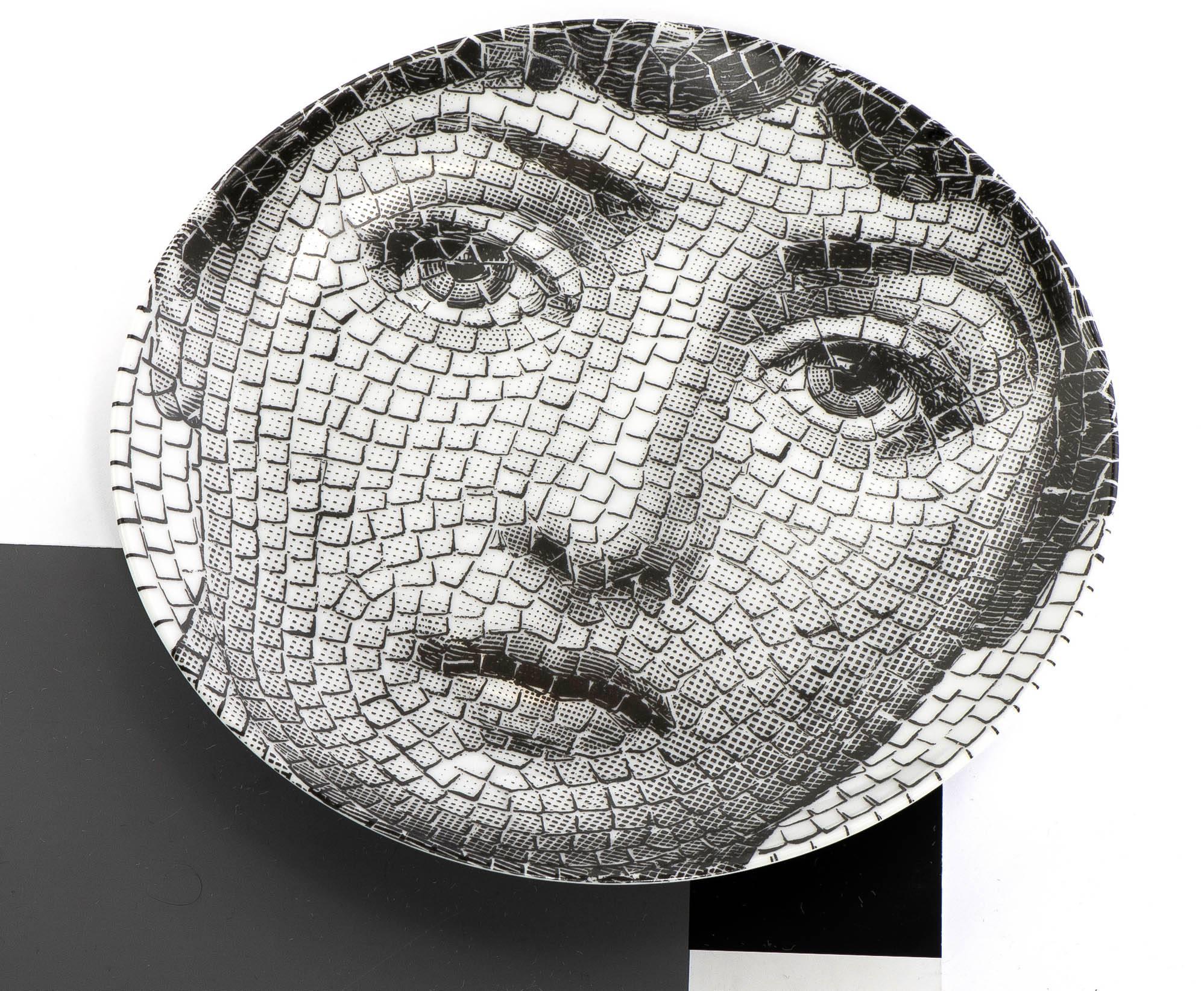 A porcelain plate by Atelier Fornasetti.
“Themes and Variations”.
Lithographically printed.
Marks to back, 
Italy, circa 1990.
Measures: 26 cm diameter.
  