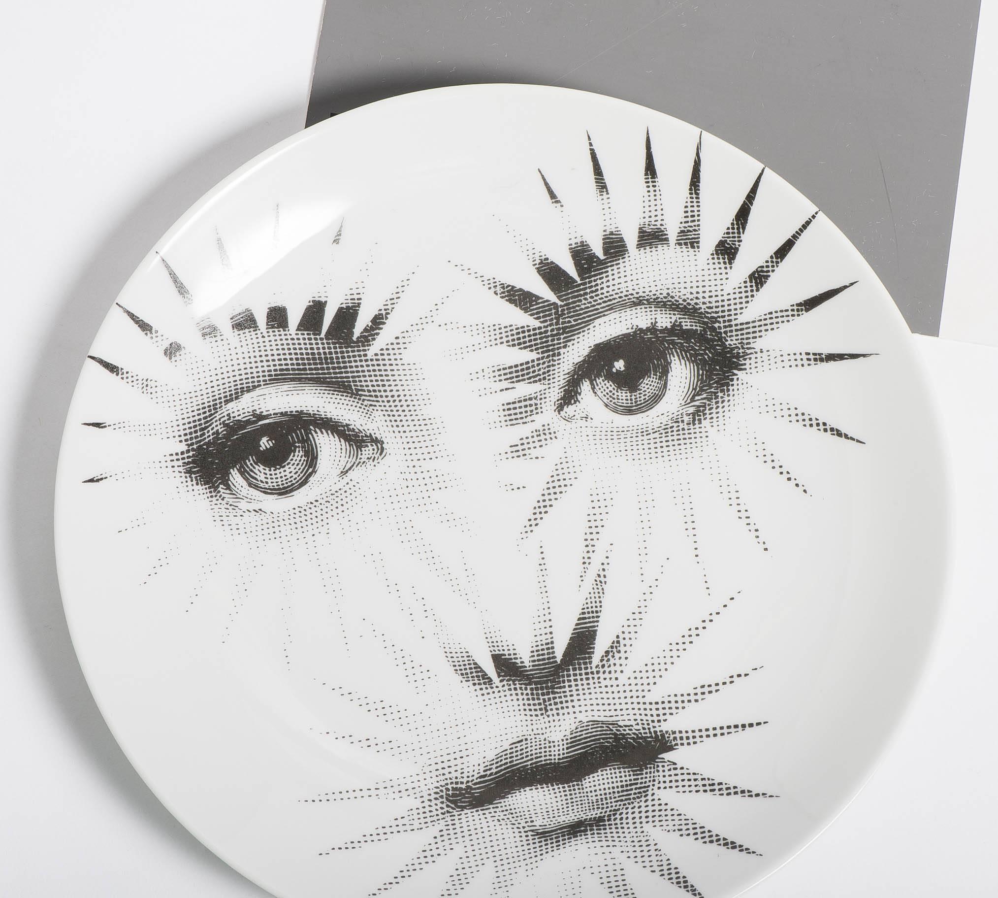 A porcelain plate by Atelier Fornasetti.
“Themes and Variations.”
Lithographically printed.
Marks to back,
Italy, circa 1990.
Measures: 26 cm diameter.
                 