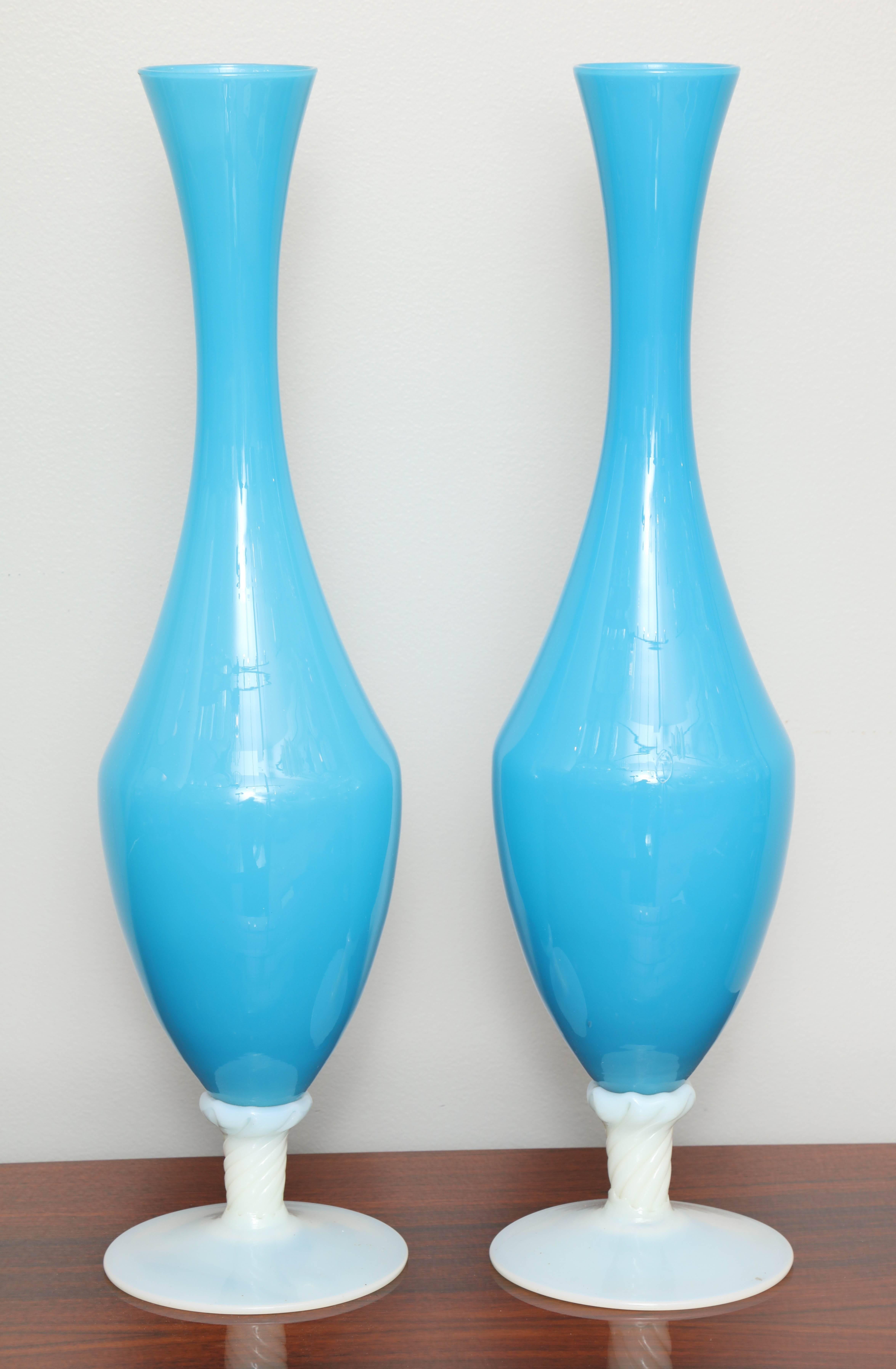 Matching blue and white opaline vases. Pair available; priced and sold individually.