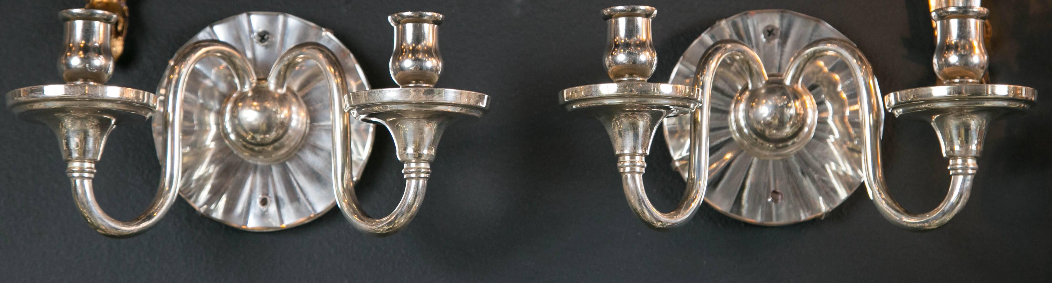 Caldwell sconces silver plated with cut mirrored backplate, circa 1920 12 available priced per pair.