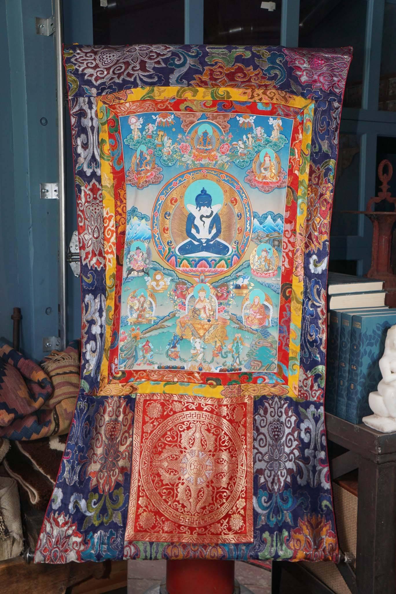 This silk, hand-painted Thankha is notable for the quality of the preservation of the paint, as well as for the number and elaboration of its panels and vivid colors. A very lovely modern (20th century) piece done in a traditional style. (Tibetan or