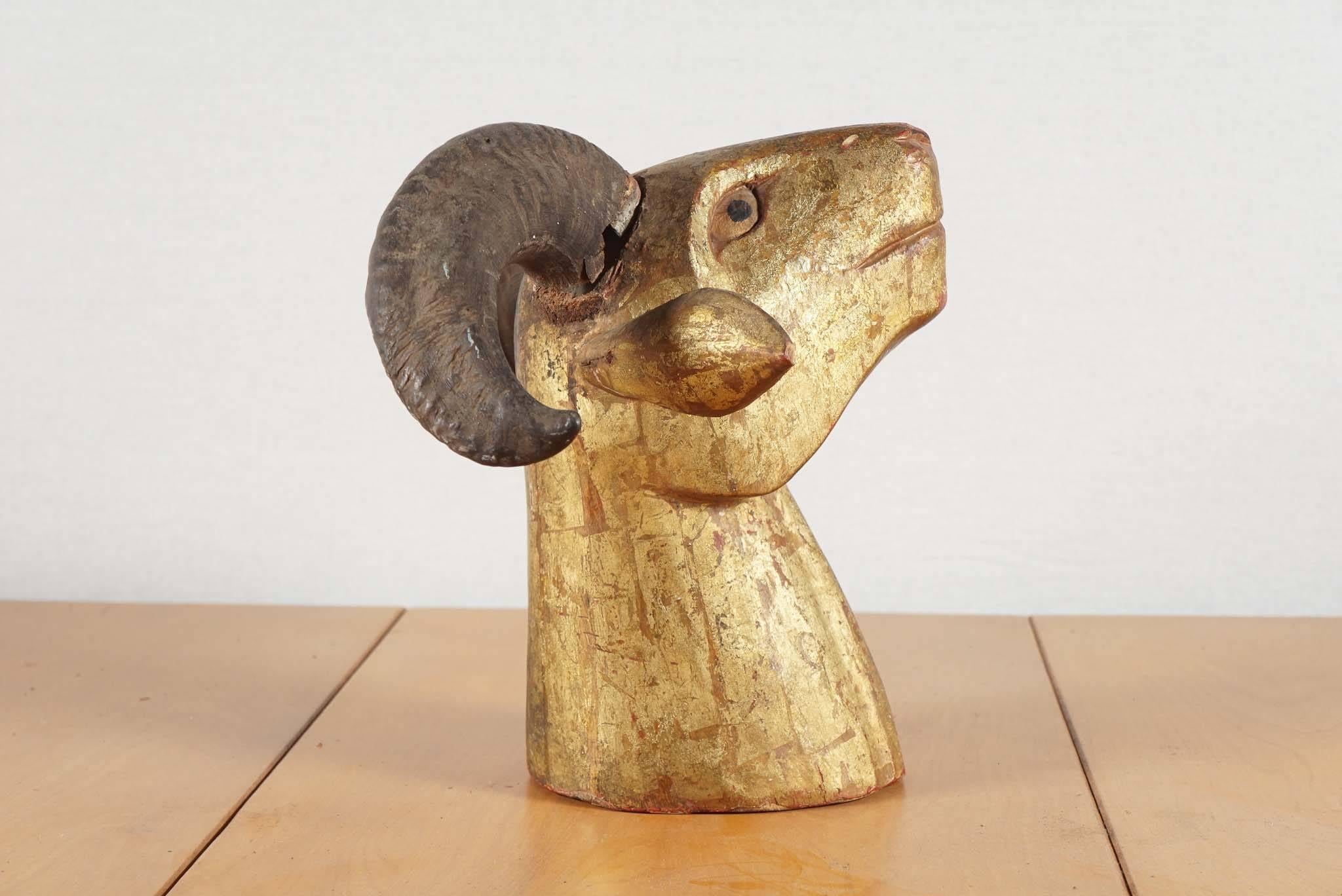 Indonesian carved wood and gold washed ram's head, circa 1920.
