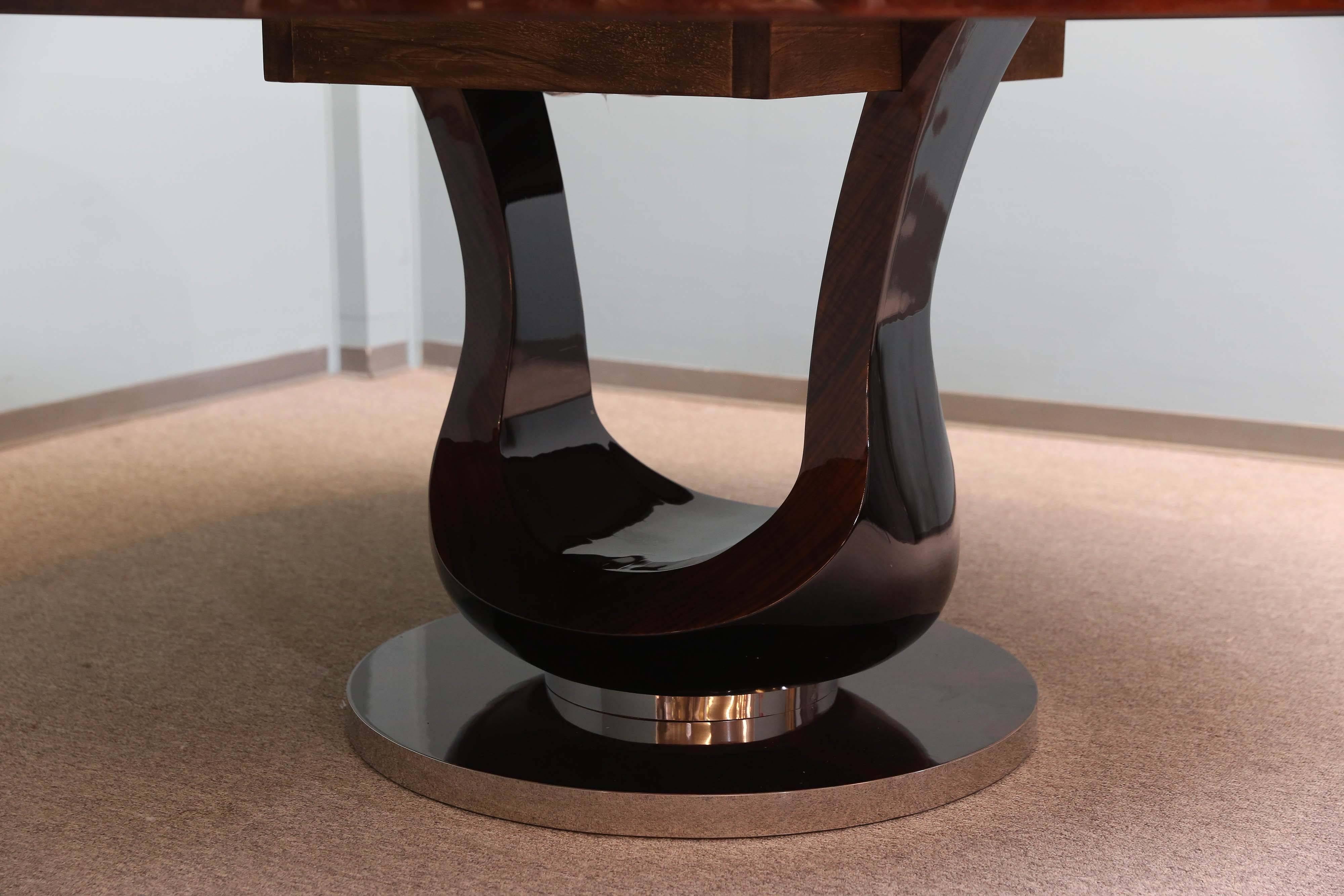Round table top is made out of walnut and presents the beauty of the wood. The wood pattern is placed the certain way to create the imitation of sun rays, which are bursting out of focal point in the middle of the tabletop. It rests on a sculpted