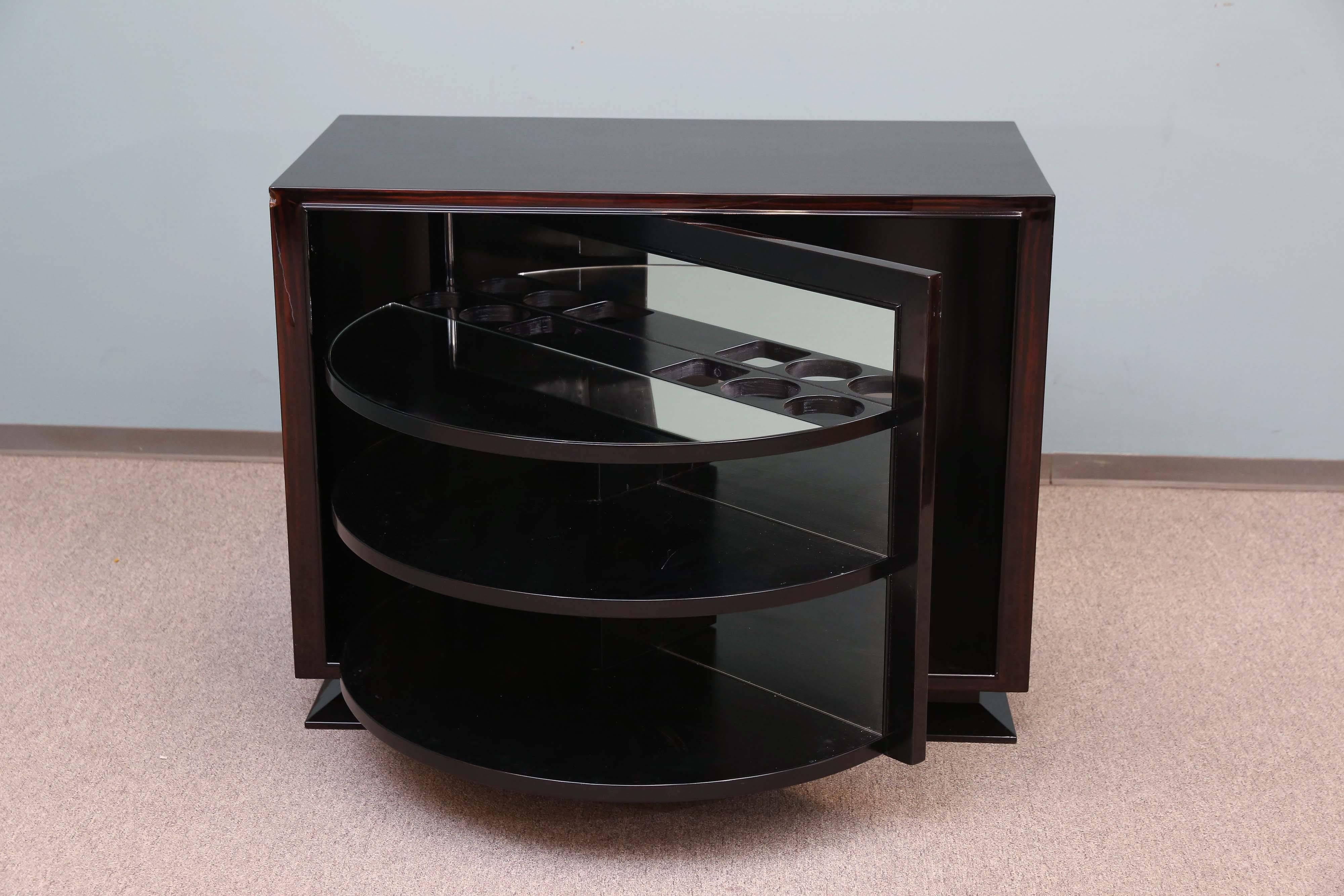 A very practical bar cabinet. Combination of walnut and Macassar veneer adorns this small breakfront. The door turns out to reveal the fitted interior to be a functional bar.
Restored,

French, circa 1930s.
Measures: 41” x 21.5” x 32”.
 