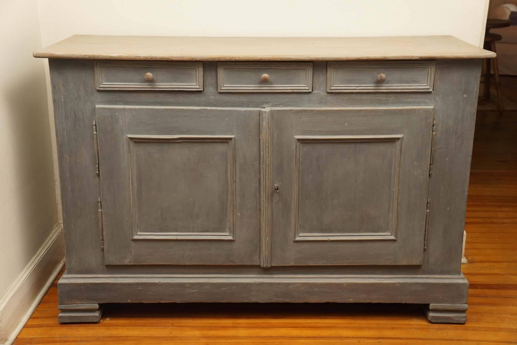 Soft dusty light blue is the signature behind this stunning buffet. Nicely paneled and a beautiful top plus nice original shelf inside make this piece flawless. Did we mention the nice bracket feet. Its beautiful!
