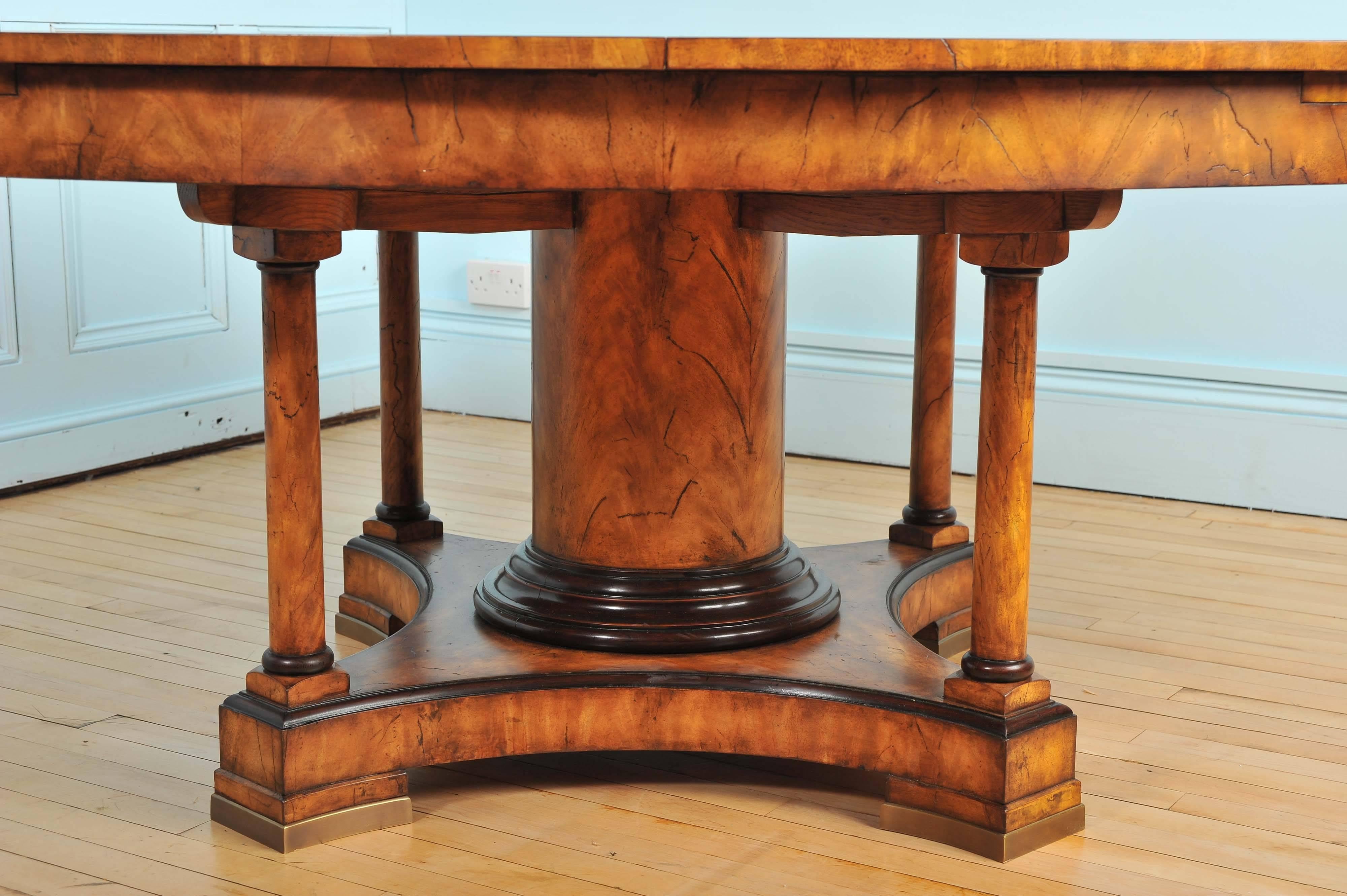 This stunning oval mahogany extending dining table features a matte finish with wood markings and grain lines for a more natural, less refined look. The table pulls apart to accommodate four large leaves, which are housed in a free standing,
