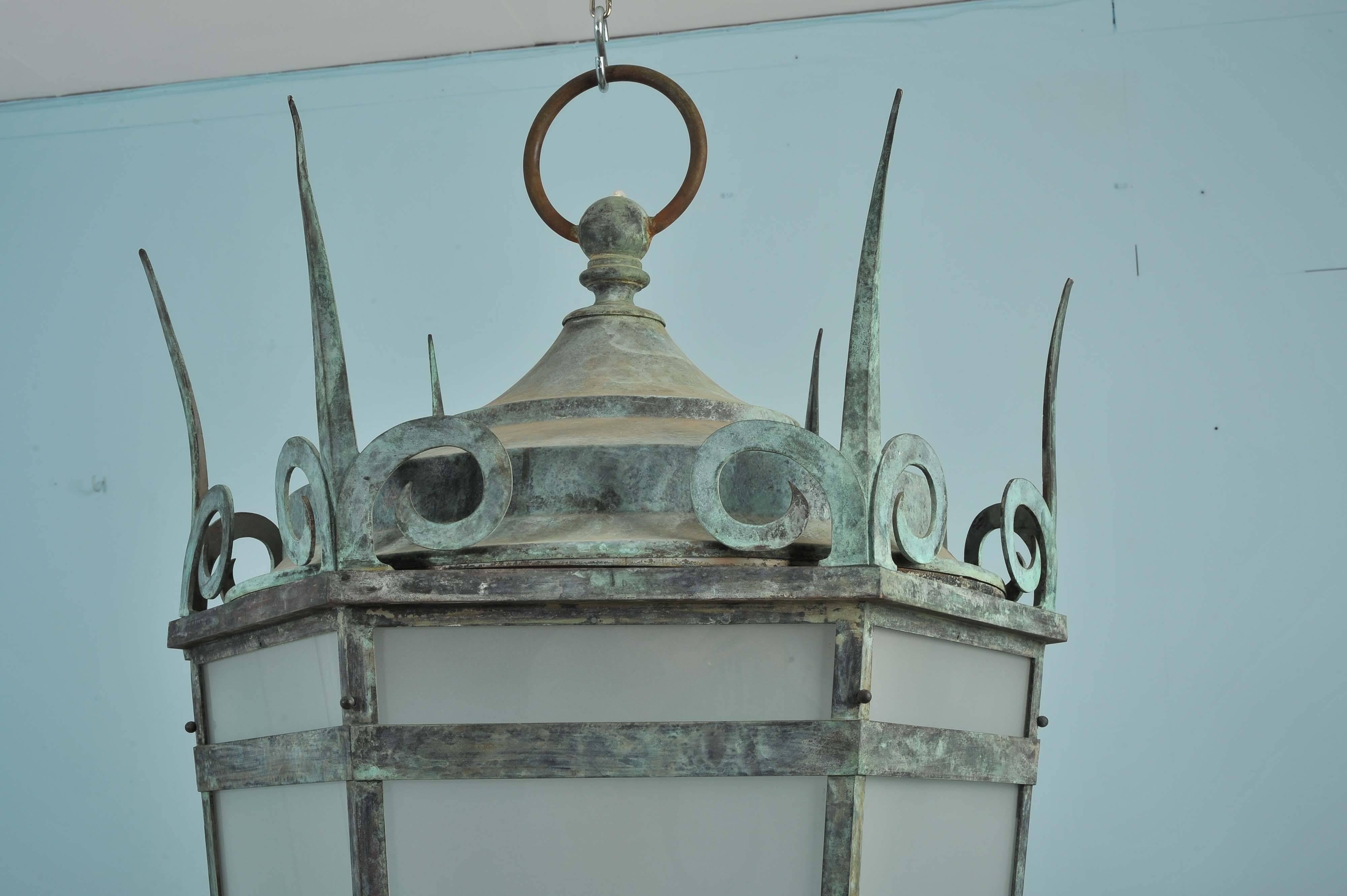 These colossal sized bronze lanterns are English, circa 1900. They have a naturally aged patina frame with frosted white glass panels and a single bayonet light fitting inside. Each lantern measures 32 in – 81.3 cm in diameter with a sizable 64 in -