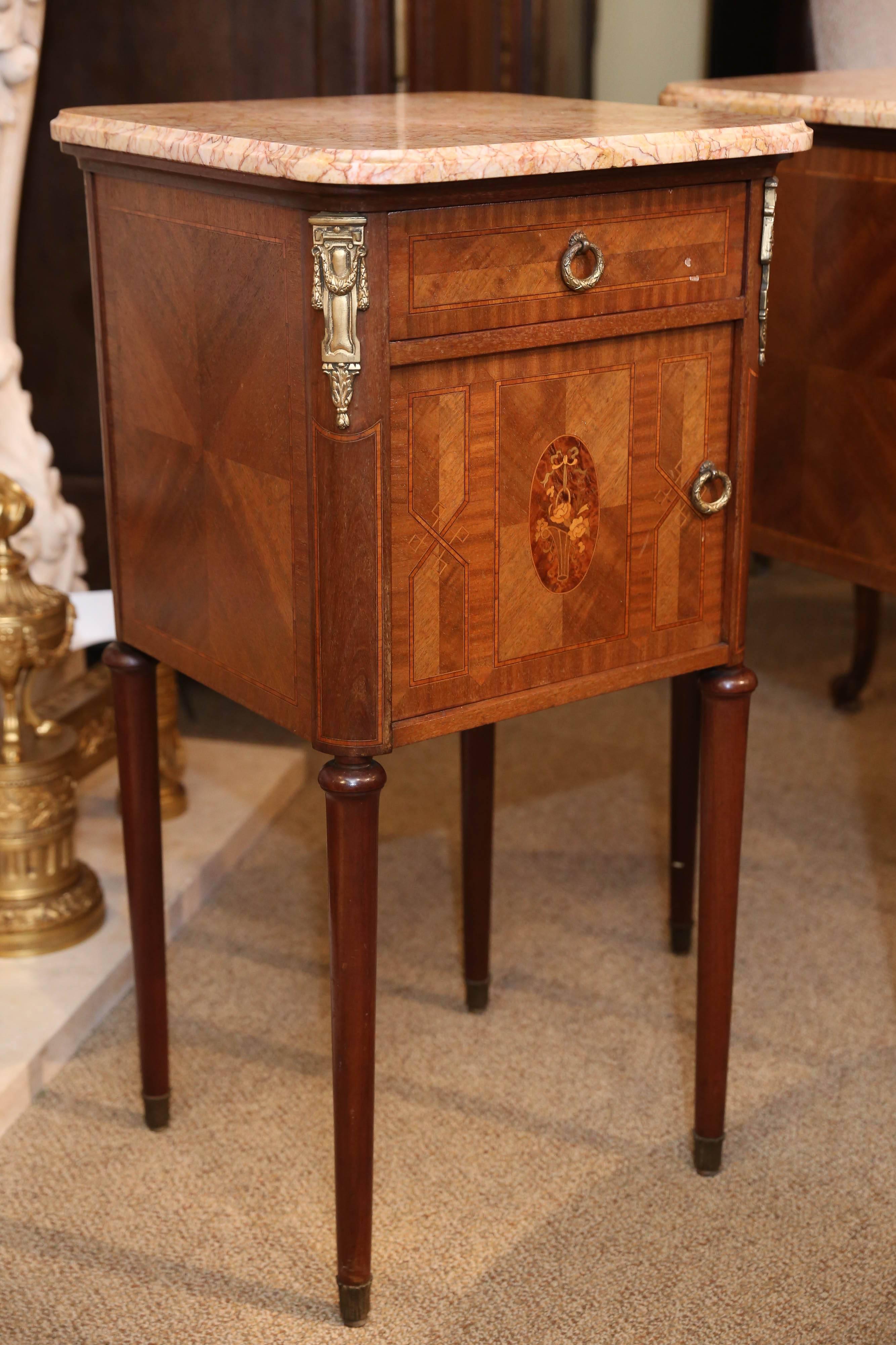 Bedside cabinets with fine inlay, marquetry cameo depicting.
Flowers in a basket, ormolu mounts.
Various woods including kingwood, satinwood and walnut.