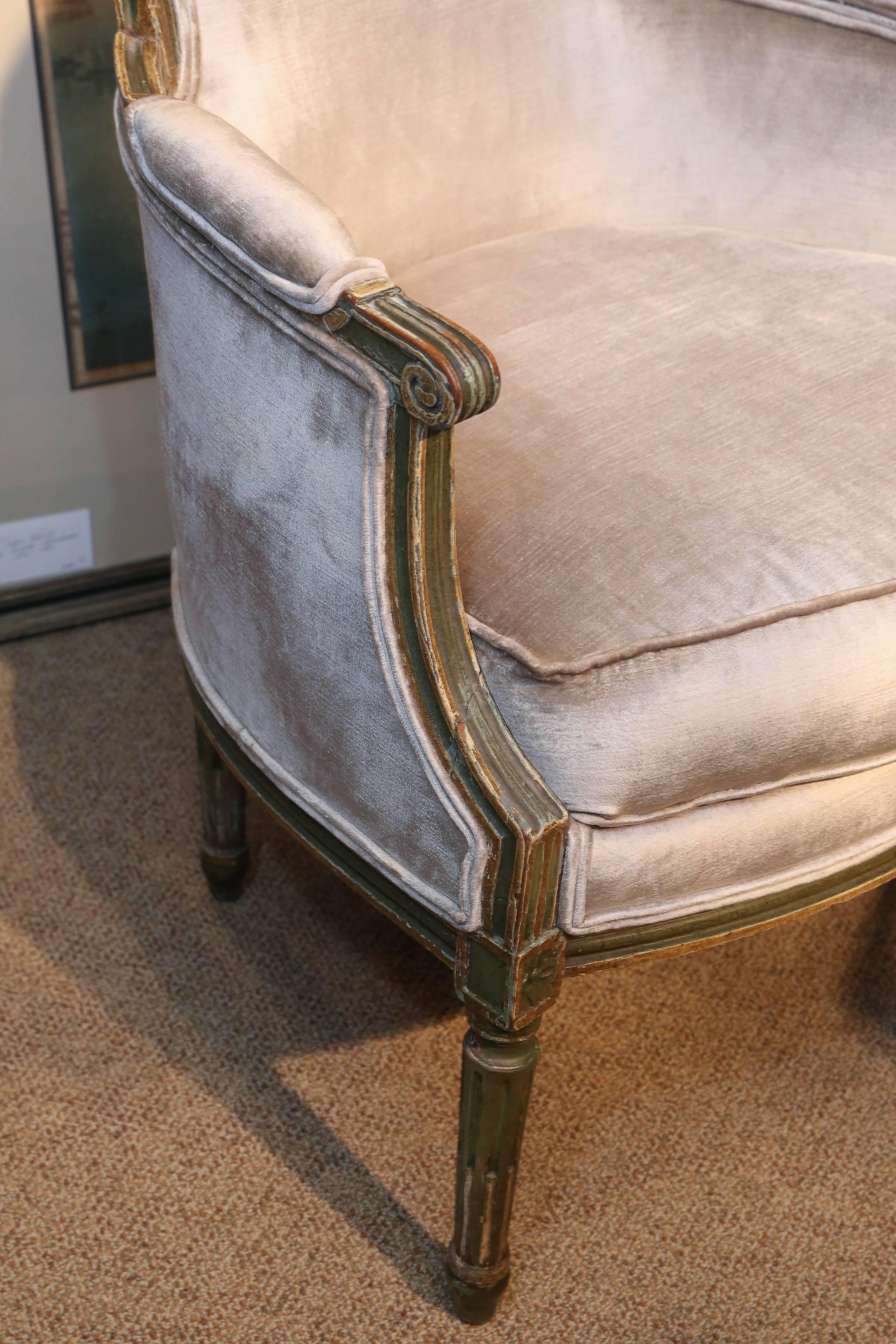 Fine pair of Louis XVI bergere chairs. Parcel paint and gilt finish.
In French green early 19th century.
These have been re upholstered in a fine pale gray silk velvet.