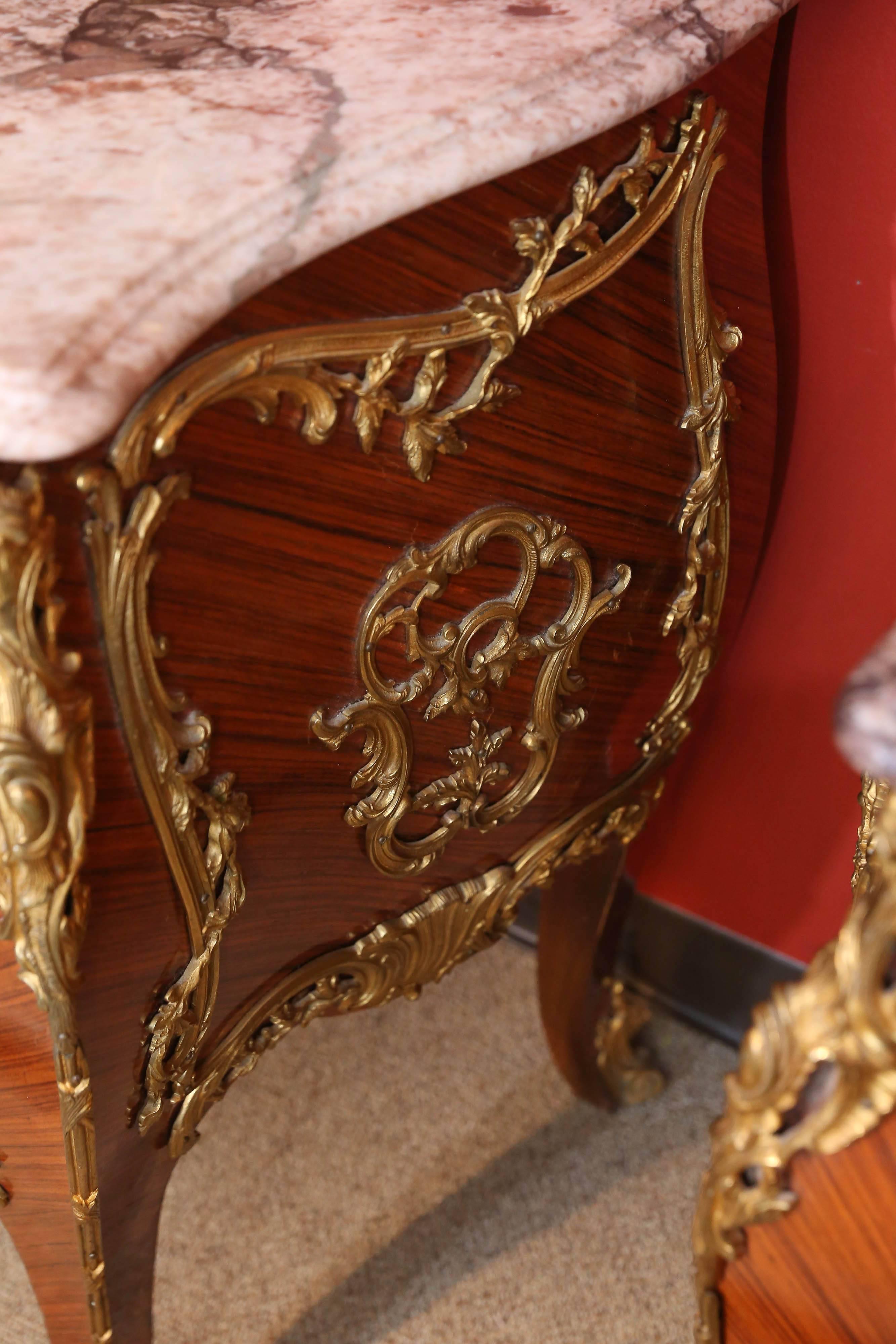 Wood Pair of French Commodes with Marble Tops and Extensive Ormolu Mounts For Sale