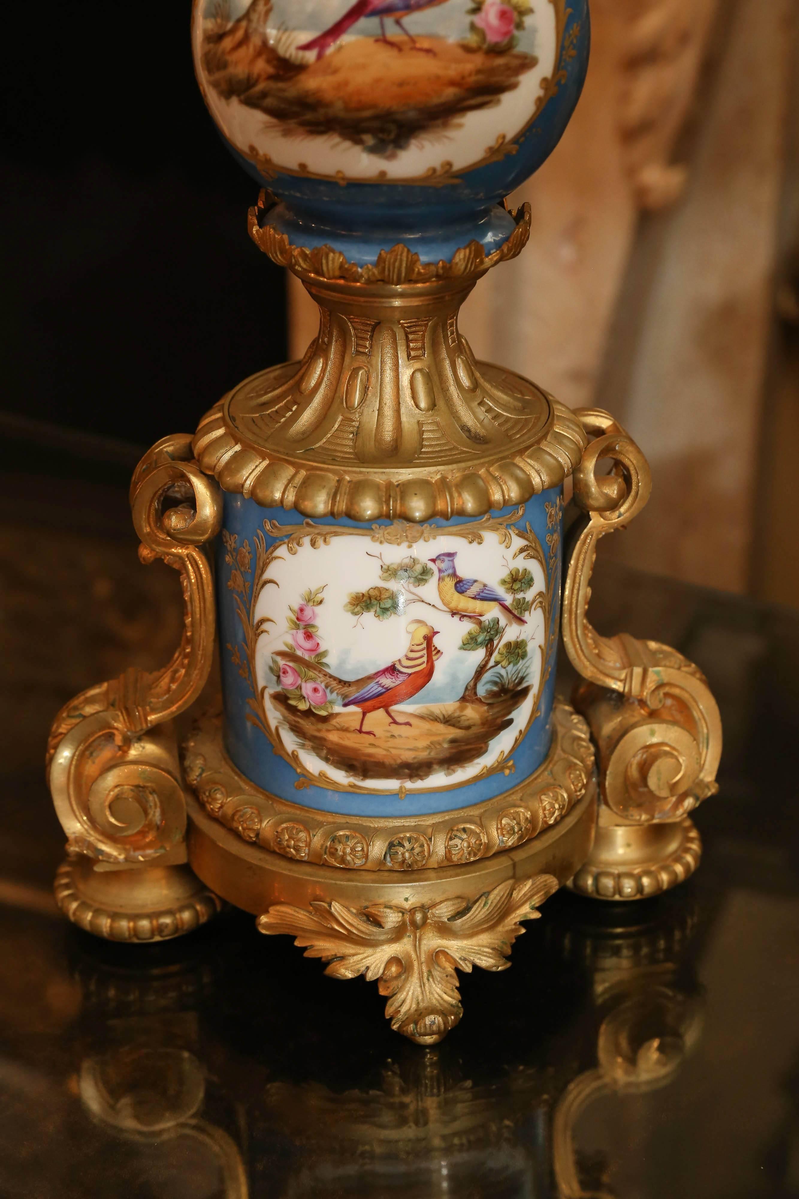 Large and impressive Sevres porcelain candelabra mounted in gilt bronze
hand-painted in Celeste blue with lovely painting of birds and flowers.