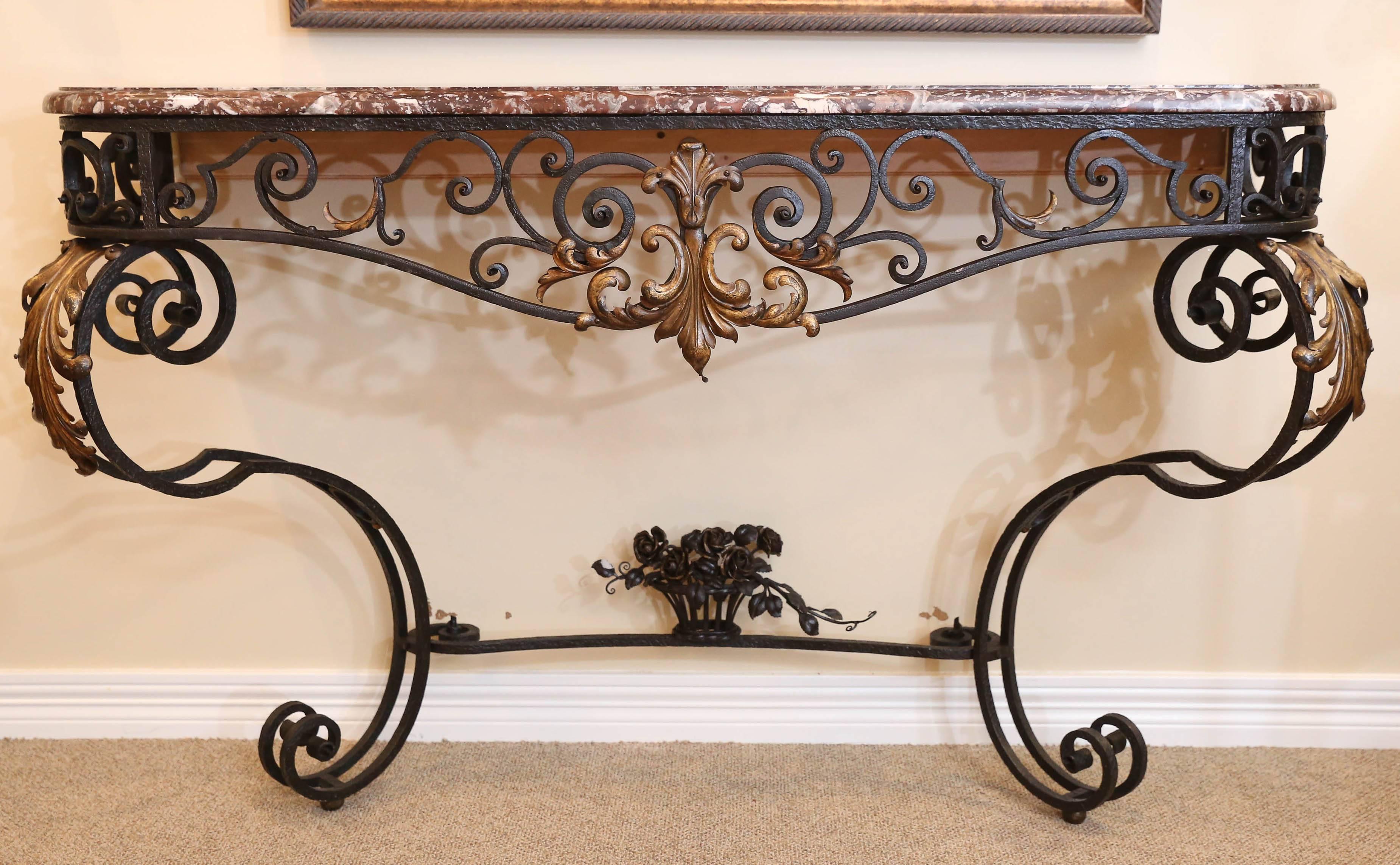 Iron console with leaf and floral detailing with rouge marble top.
Fine detail work and scrolling legs with a lovely bowed and scrolled
front that dips gracefully.