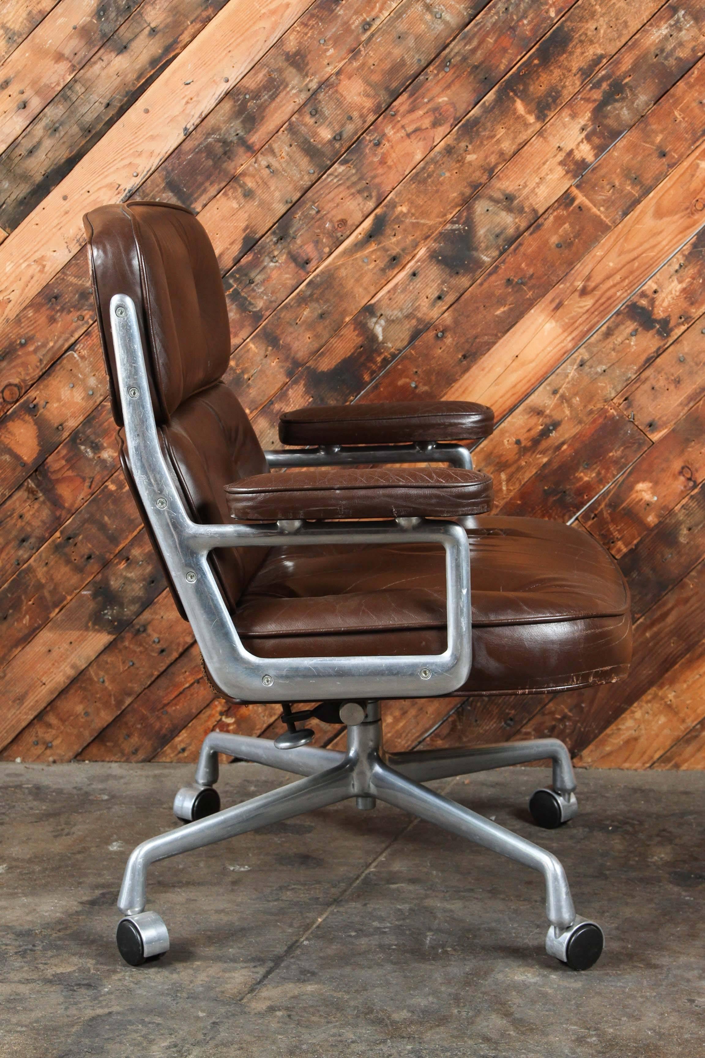 The most iconic office chair. Thick and comfortable pad. Designed by Charles & Ray Eames. These conference chairs were designed for the Time Life building in New York. Gorgeous rich brown leather shows a beautiful all-over patina with better than