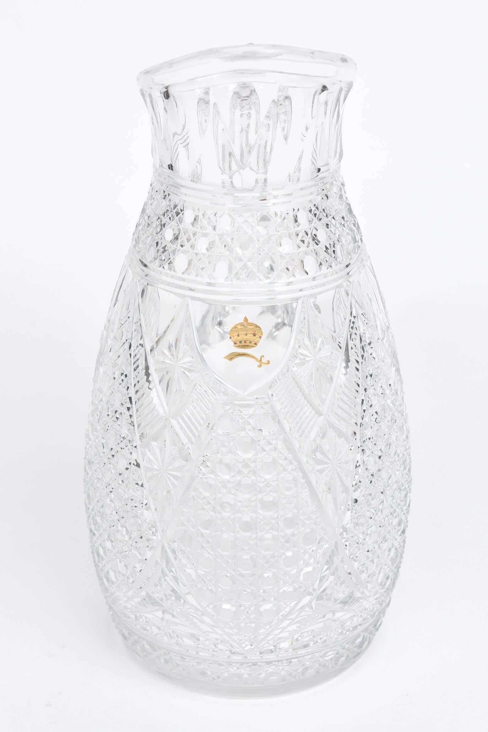 An unique and signed piece from the storied glass firm of Baccarat, France. Intricate pattern design and cuts distinguish this fine piece to highlight your bar. Custom-made and featuring the crest for the sultan of Brunei. Museum quality and in