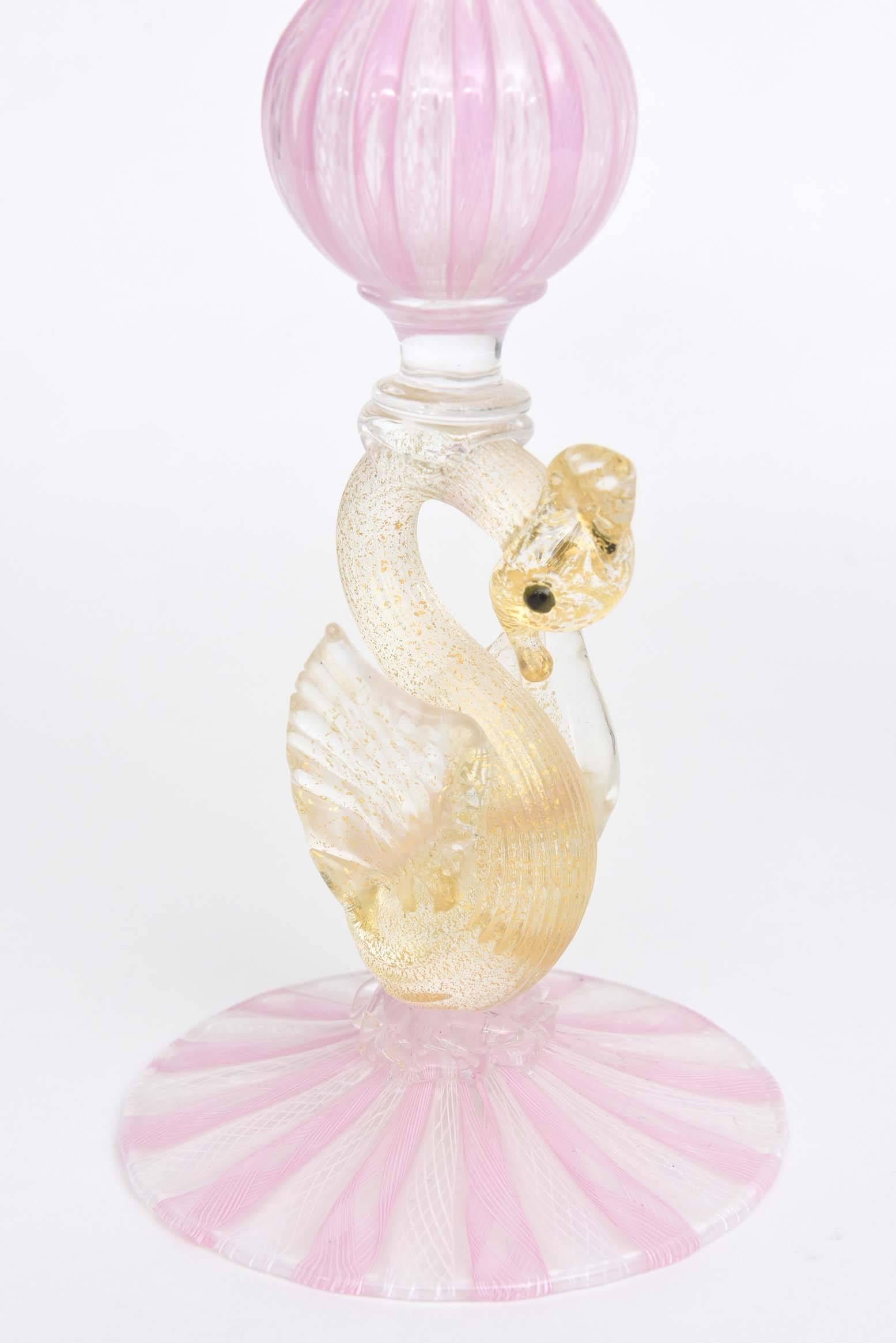 A delightful pair of pretty pink and white candlesticks or vases from the Isle of Murano. Nicely detailed and they have the traditional blown 24-karat gold infusion decorating the swans. Classic and elegant with or without candles or flowers.