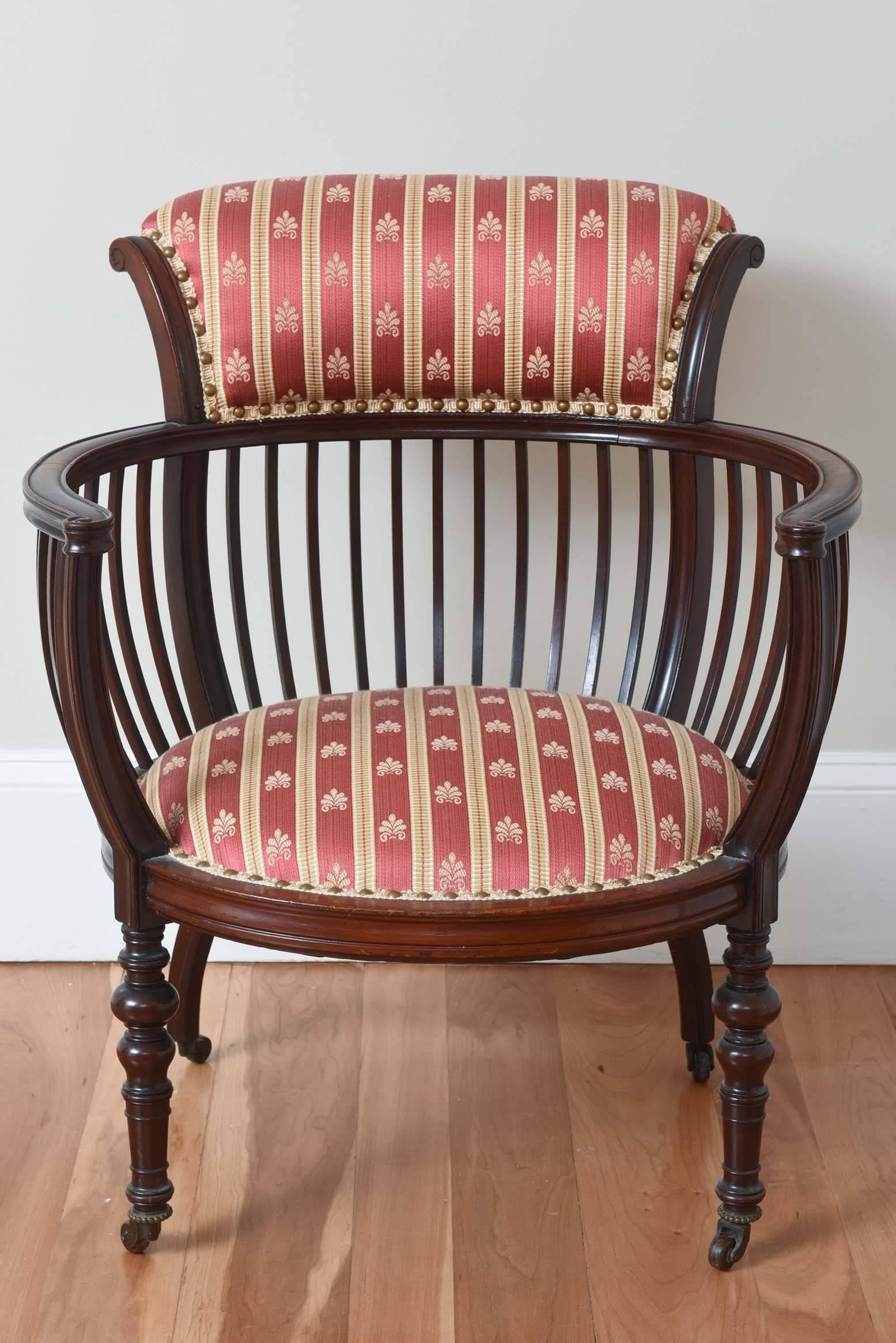 A charming handcrafted chair in wonderful antique condition. Nicely carved legs and well proportioned shape. Retaining its original brass nailheads.