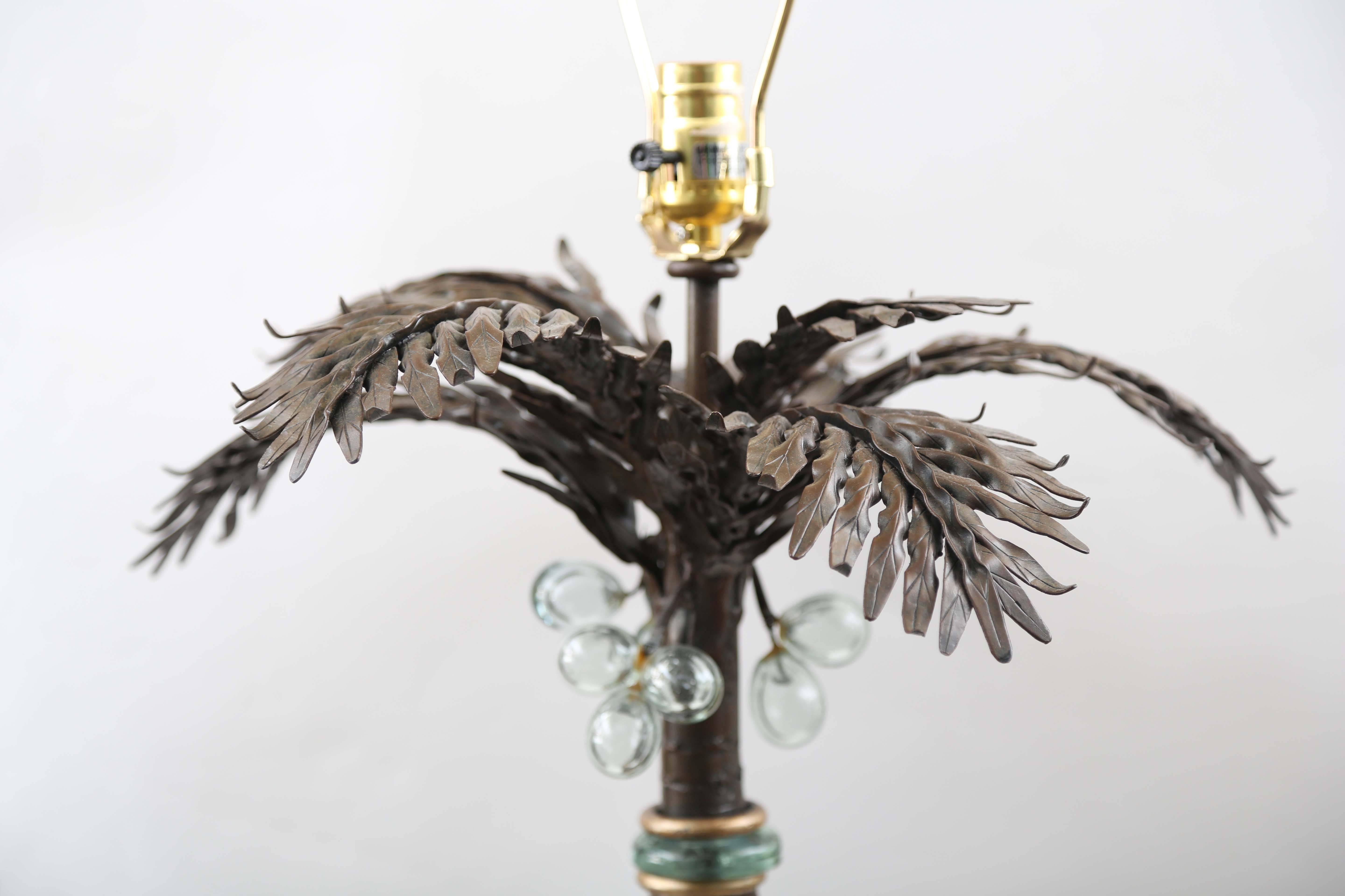 Stunning pair of bronze palm tree lamps wrapped in cord and adorned with aqua glass coconuts.