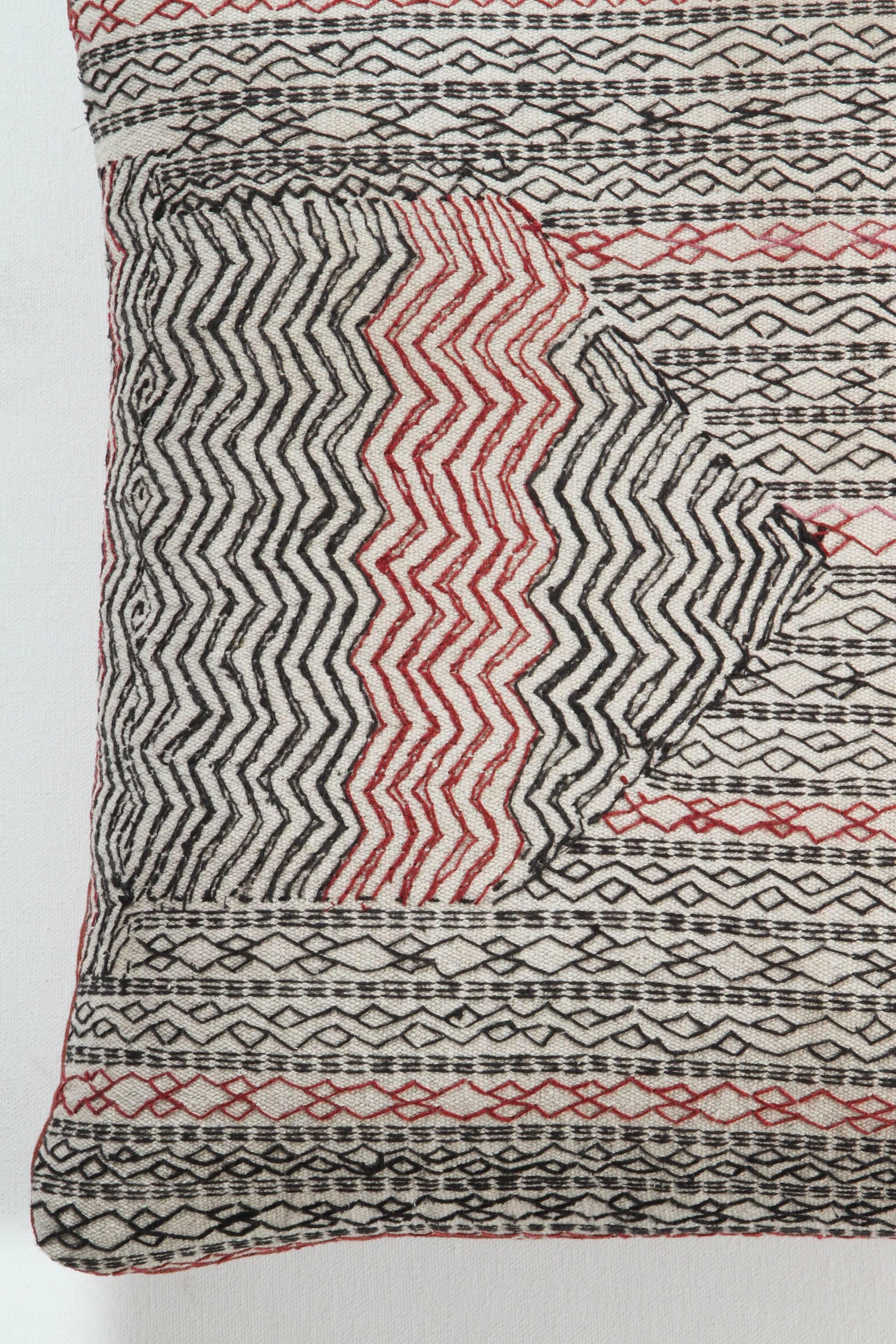 Vintage cotton on cotton embroidery producing a heavy quilted effect. Shades of black and white and (red). Zig zag and geometric striped Vintage cotton on cotton embroidery producing a heavy quilted effect. Shades of black, white and red. Zig zag