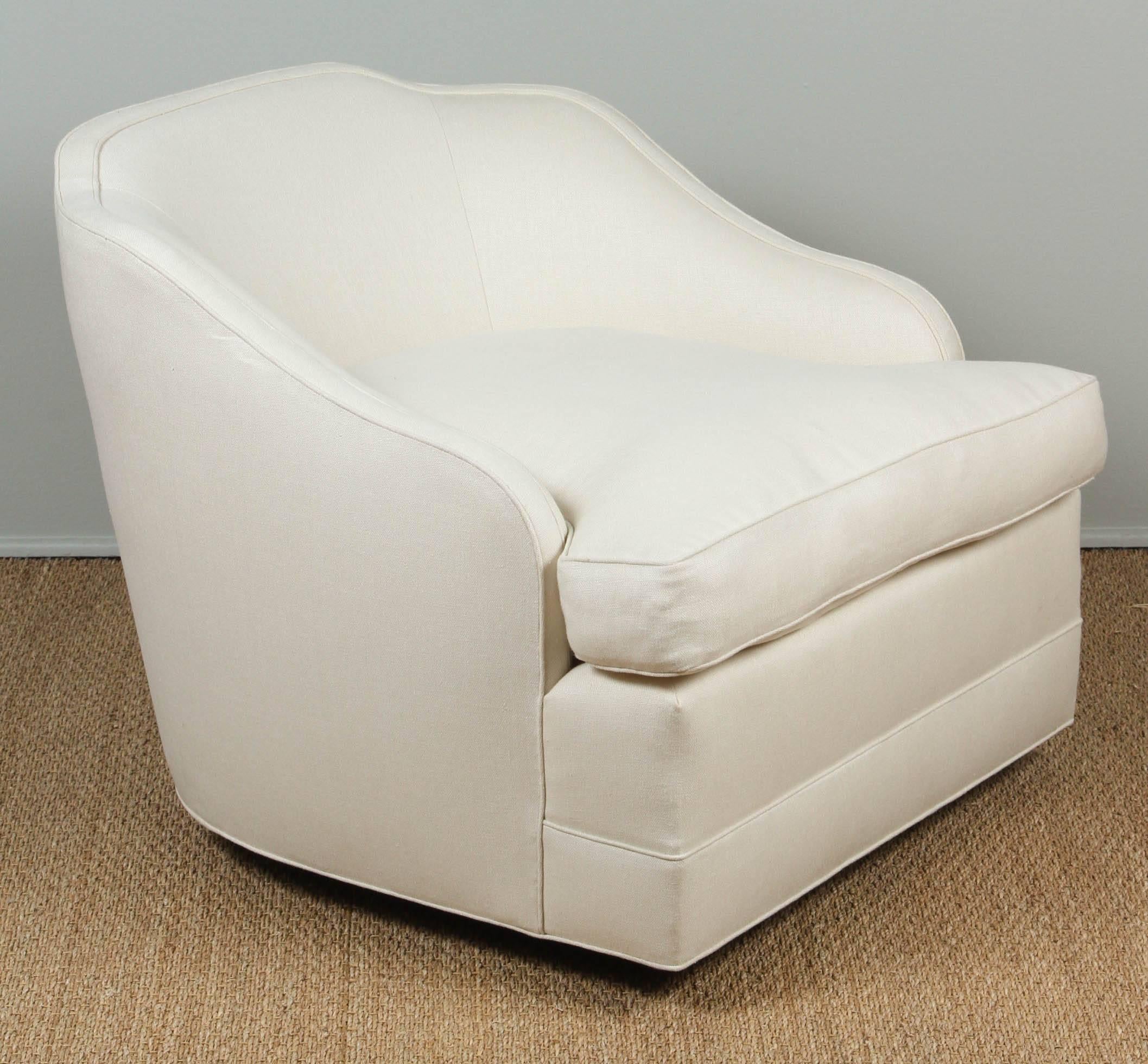 Updated white linen upholstery. New feather and down seat cushion. Swivels on a wood base with caster wheels.