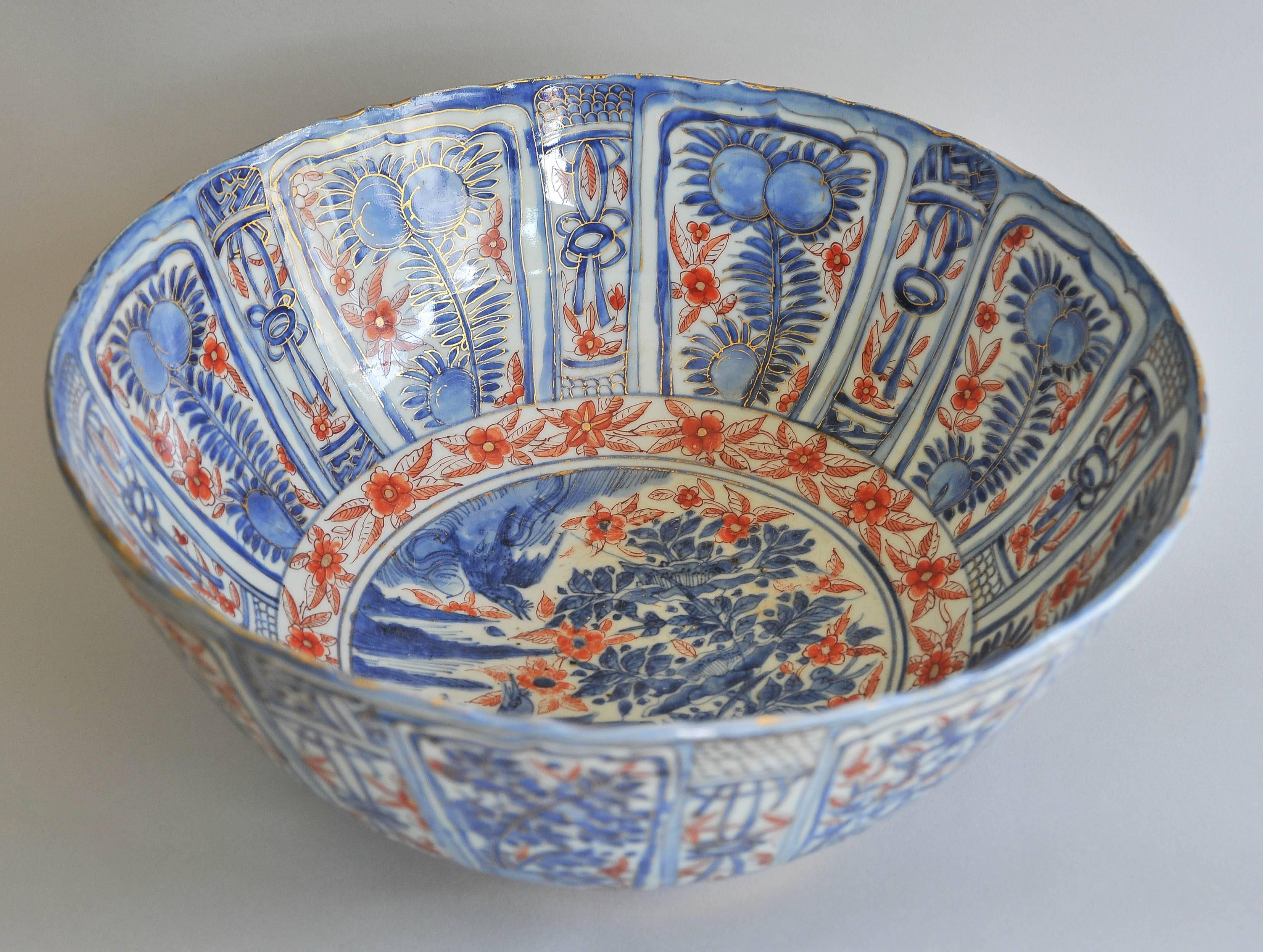 A large Chinese Wanli period (1563-1620) blue and white porcelain bowl in perfect condition depicting several panels with flowers and tree branches and a scene with birds in the center. The bowl has been later highlighted around 1750, possibly in