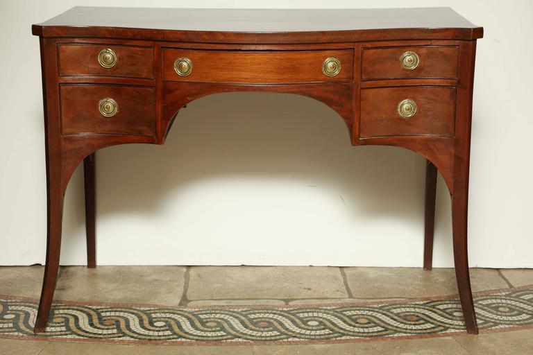 George III serpentine front mahogany sideboard server with French out-flaring legs.