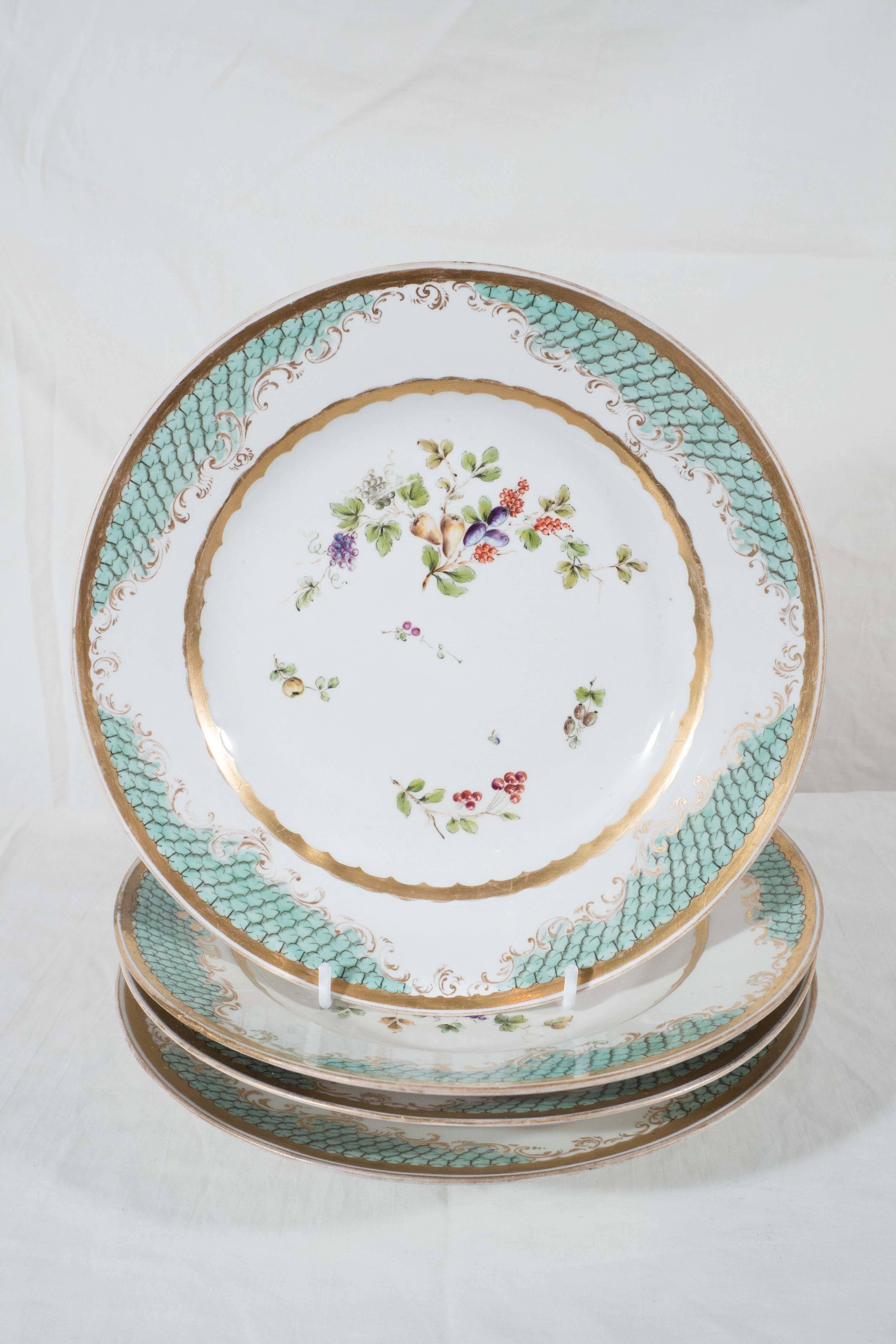 A set of eleven early 19th century dishes. These plates have a beautiful 
seafoam green border. The well is delicately decorated with fruits and flowers framed by a ring of gold.
Made by the Imperial Vienna Porcelain Factory (Royal Vienna