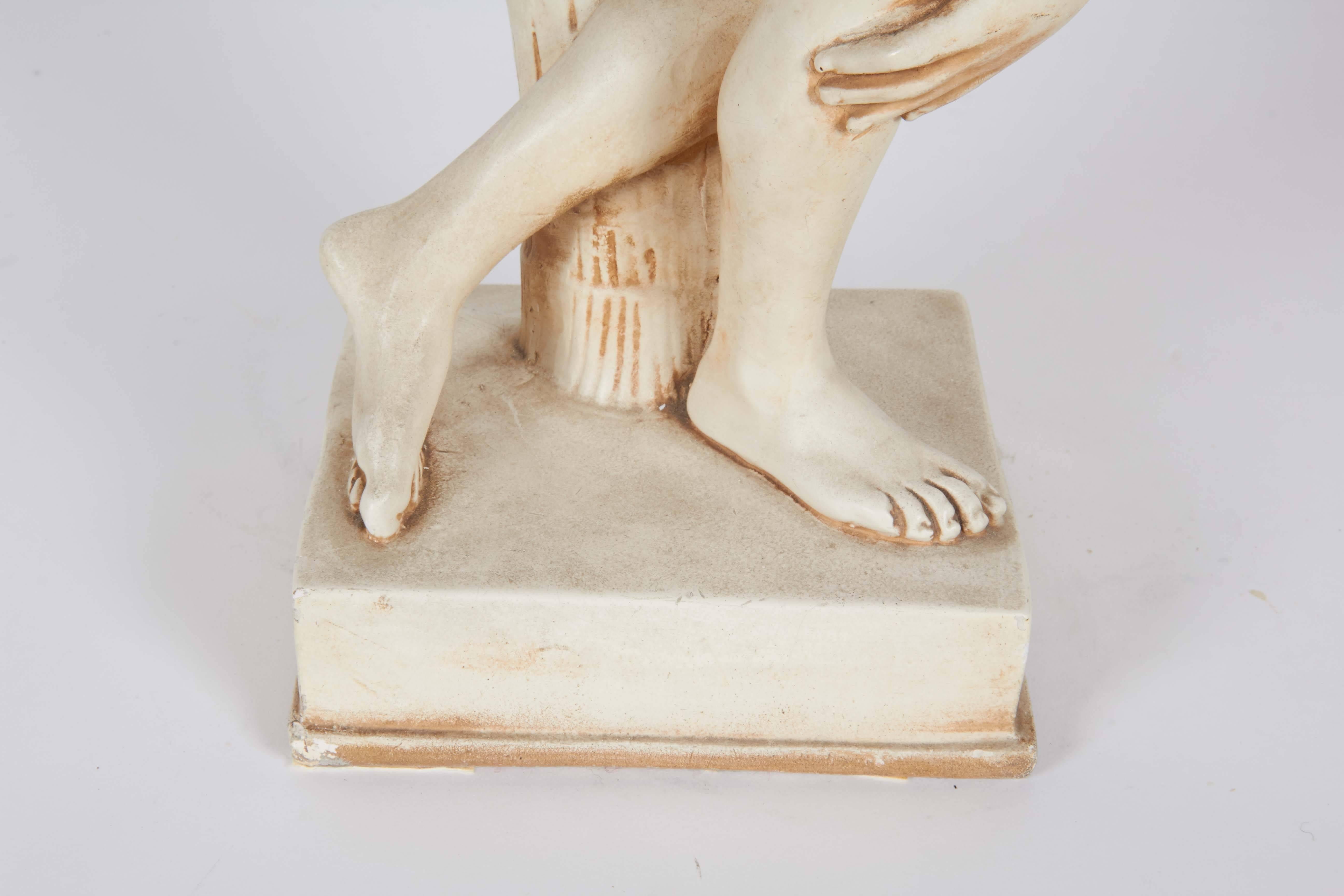 A small-scale sculpture of a discus thrower in cast resin, modeled after the famous Lancellotti Discobolus, the Roman marble copy of the ancient Greek original bronze by sculptor Myron. This piece remains in very good condition, consistent with age.