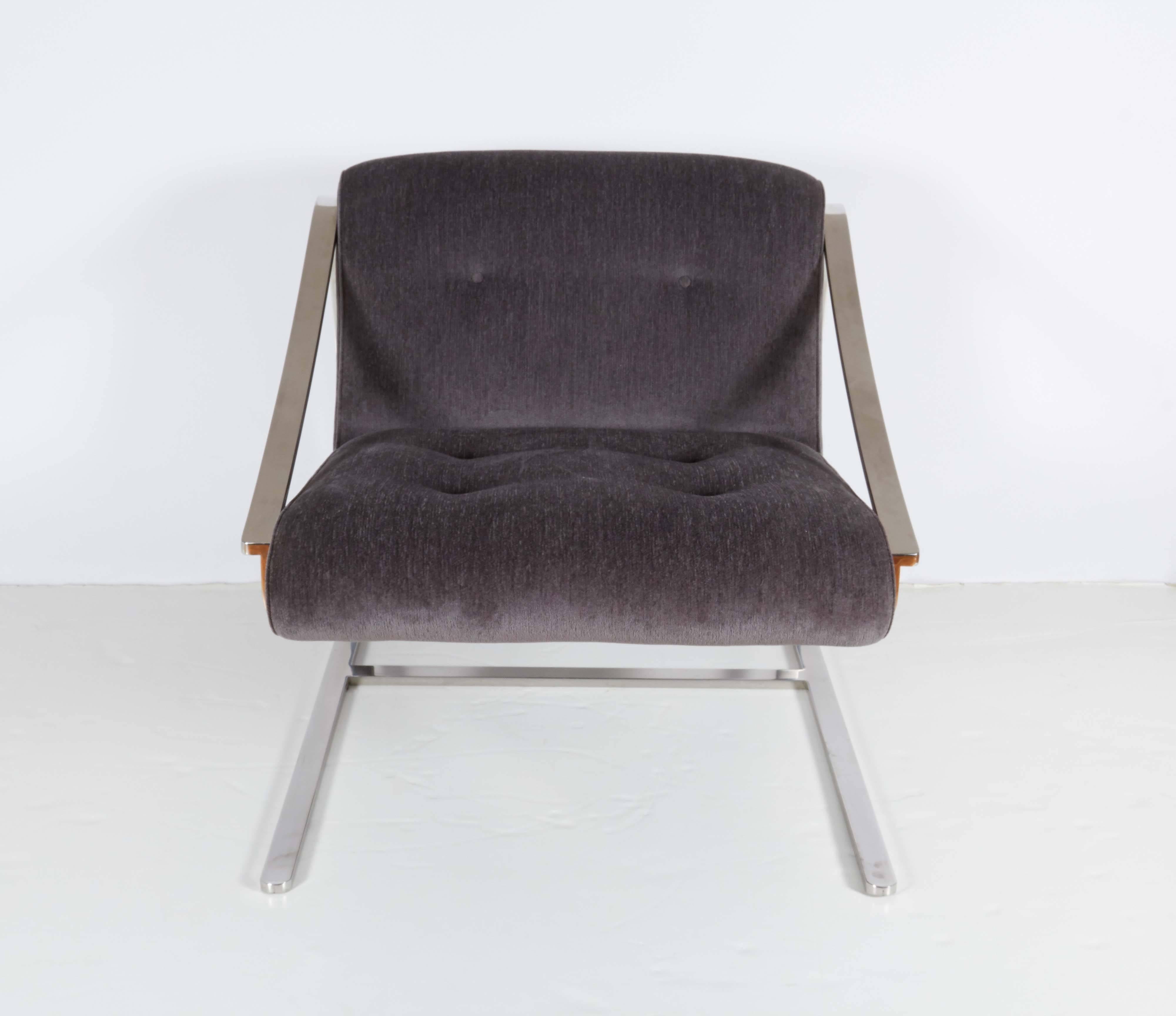 A pair of modernist style Charles Gibilterra 'Plaza' lounge chairs, manufactured circa 1970s by Brueton, the cushioned back and seat upholstered in tufted gray velvet, against a sloping sleigh frame in polished chrome. Very good vintage condition,